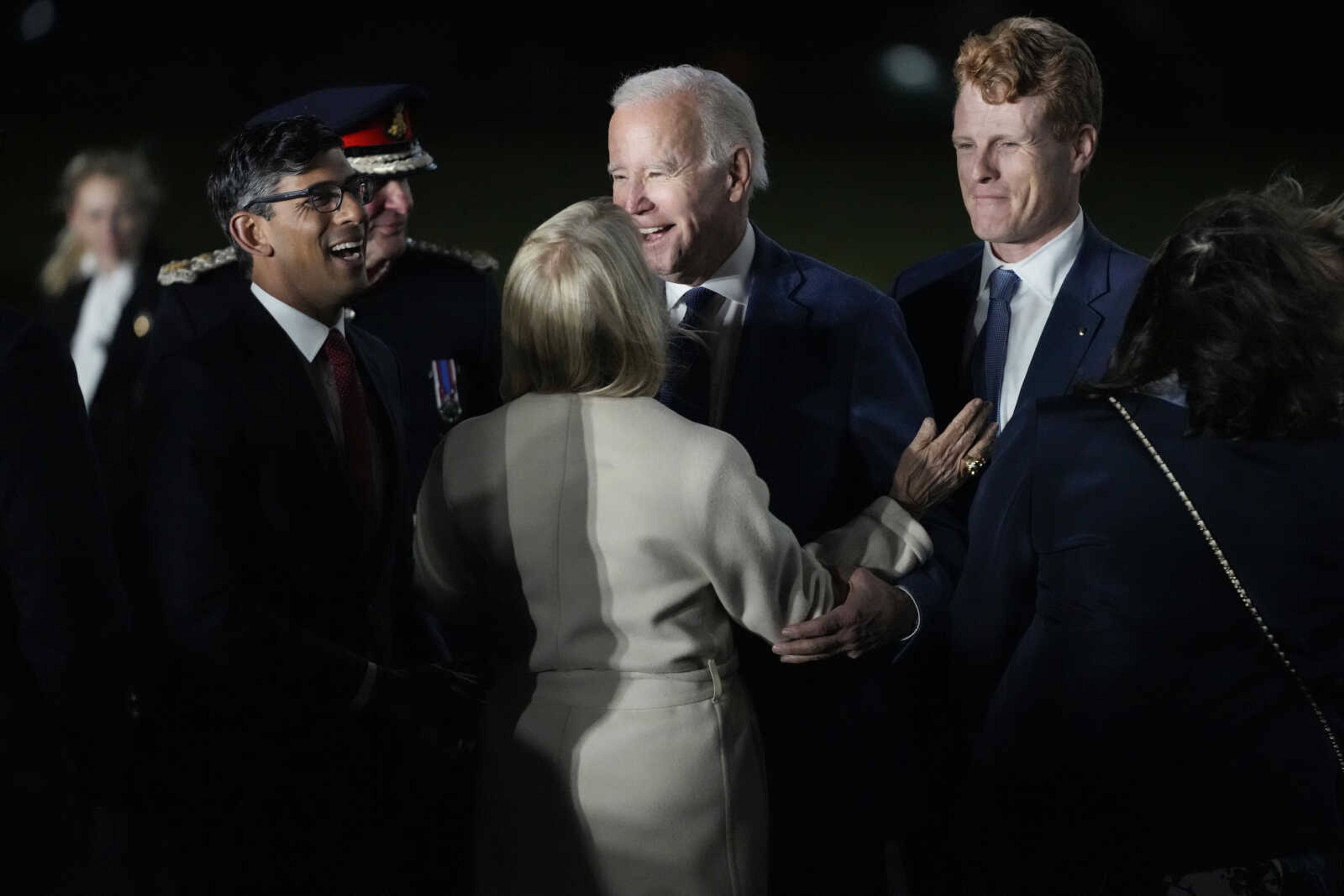 President Joe Biden is greeted by British Prime Minister Rishi Sunak, left, and U.S. Ambassador to the United Kingdom Jane Hartley, center, he steps off Air Force One on Tuesday at Belfast International Airport in Belfast, Northern Ireland. Biden is visiting the United Kingdom and Ireland in part to help celebrate the 25th anniversary of the Good Friday Agreement. At right is United States Special Envoy for Northern Ireland Joe Kennedy III.