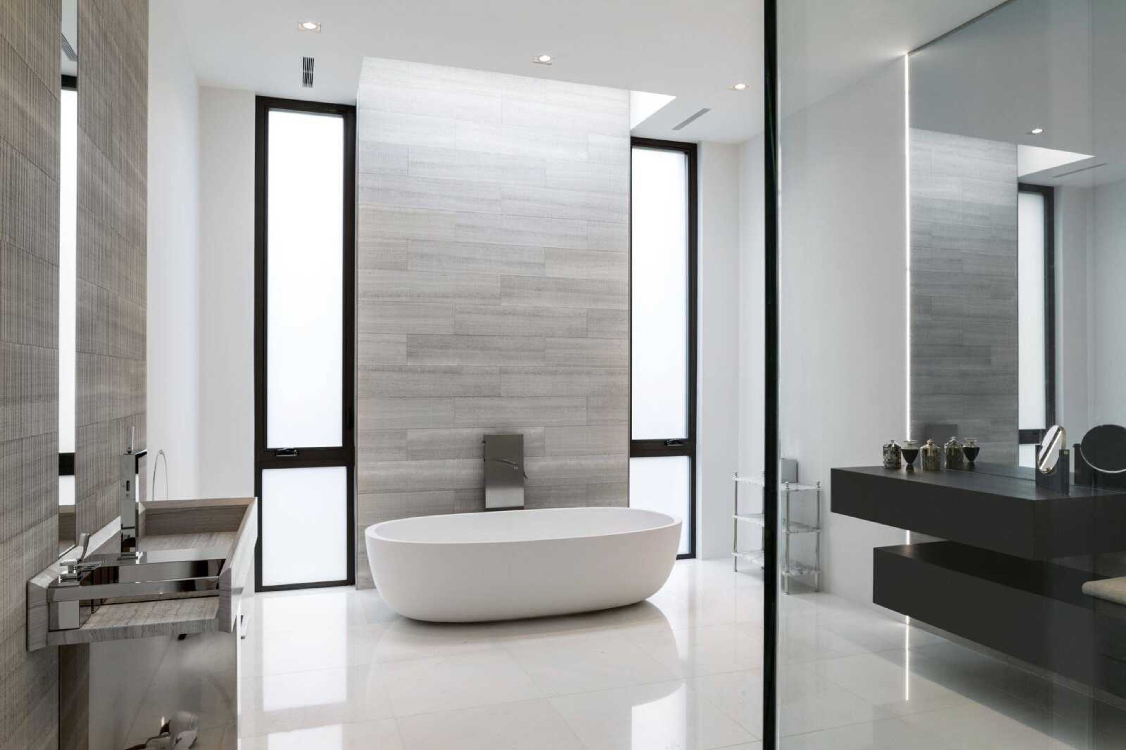 This photo shows the contrast of painted walls and tiled areas, as seen in this McLean, Virginia, master bathroom, which can make the tiles a more noticeable focal point. In assessing trends for the new year in bath design, interior designer Julia Walter says many homeowners are only tiling parts of their master bathrooms. (Angie Seckinger/Boffi Georgetown via AP)