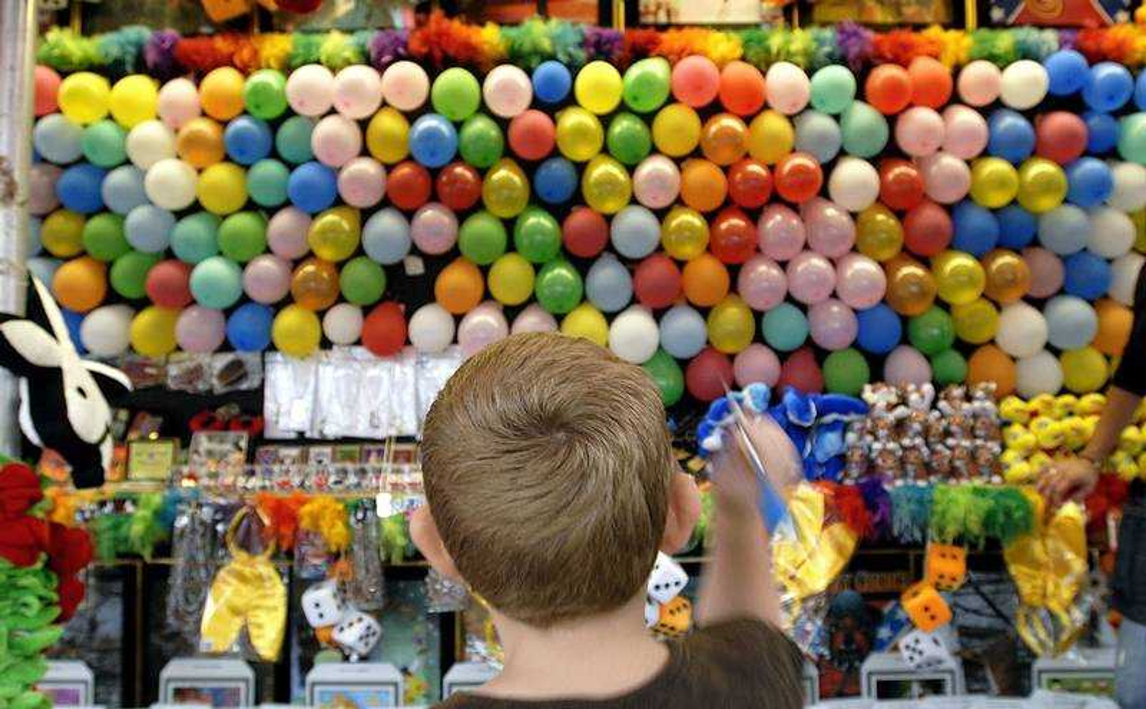 John Riehn, 9, of Millersville threw darts at balloons Friday evening at Jackson Homecomers. With the points he won, Riehn chose a Pokemon character as a prize.