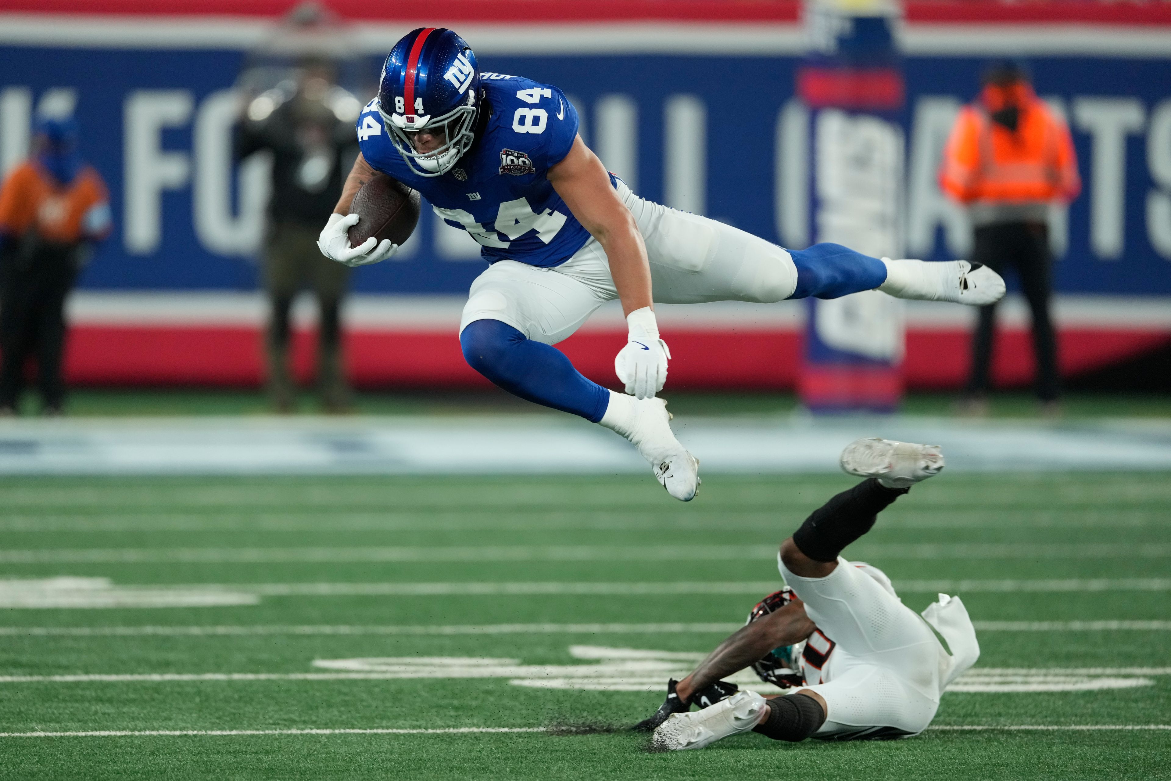 New York Giants tight end Theo Johnson (84) leaps over a Cincinnati Bengals defender during the second half of an NFL football game, Sunday, Oct. 13, 2024, in East Rutherford, N.J. (AP Photo/Seth Wenig)