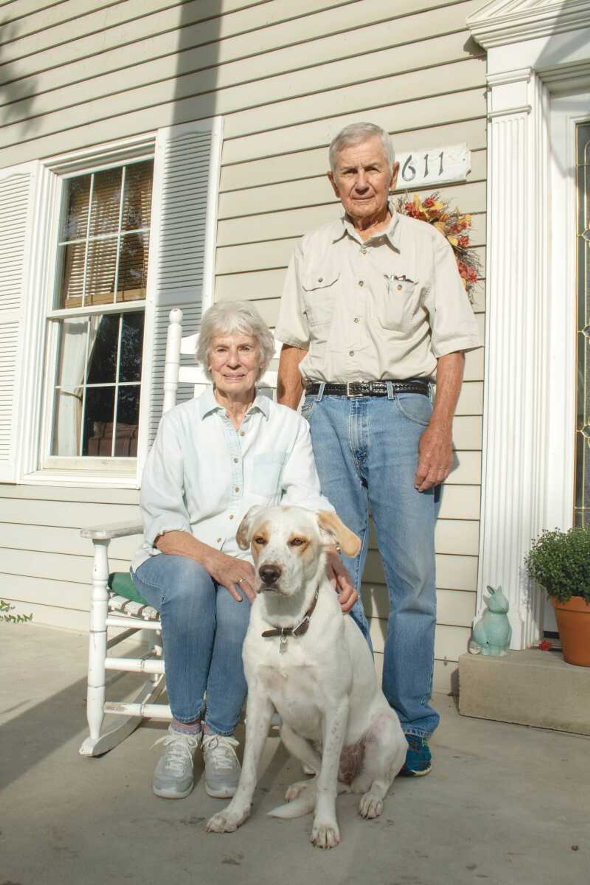 John and Janet Miller take a photo with their dog Brittany at their house in Millersville. 
