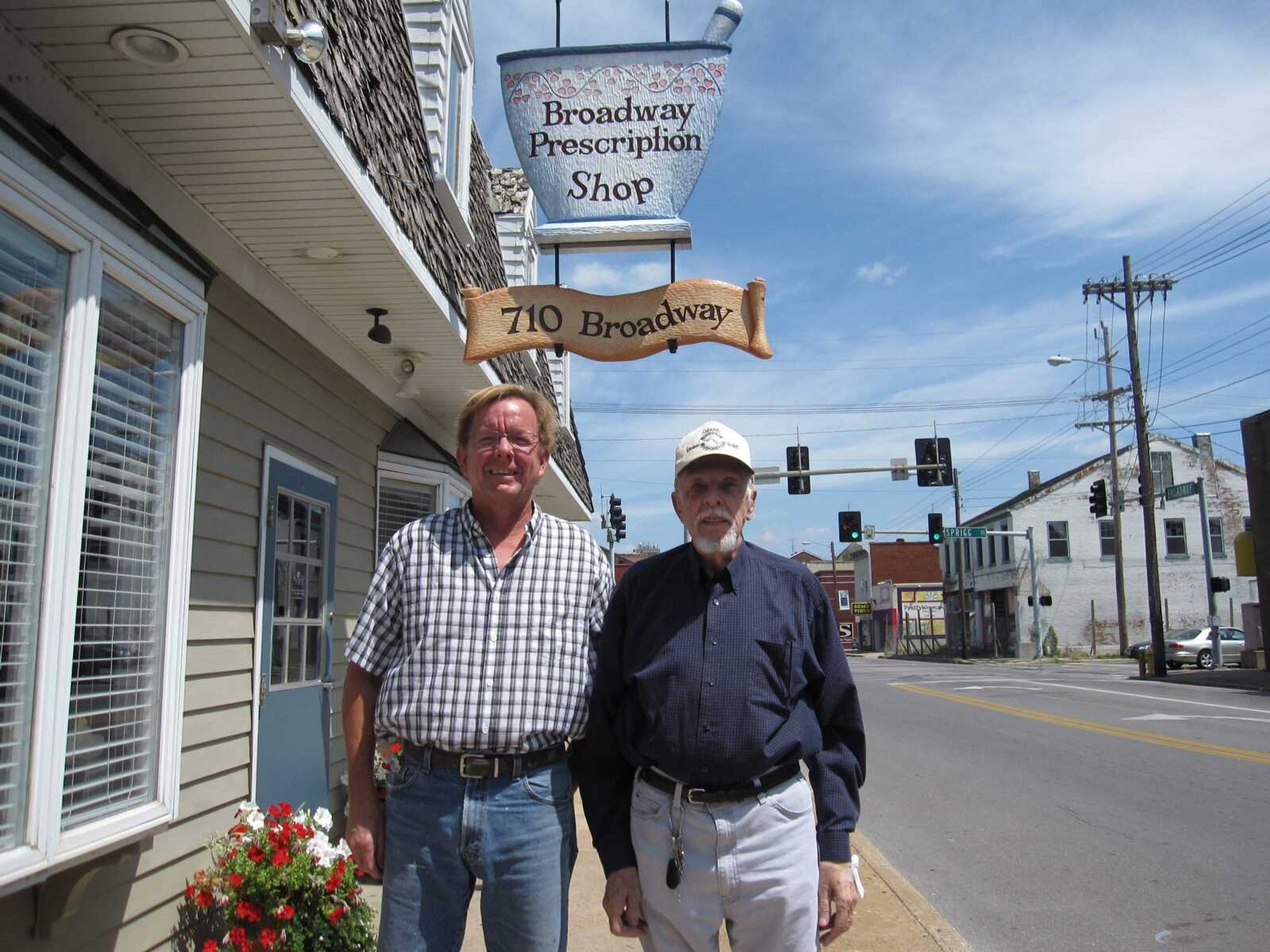 Broadway Prescription Shop’s original wooden sign, which dates back to the 1970s, has been restored to its original glory by local artist Tim Birk Roth.