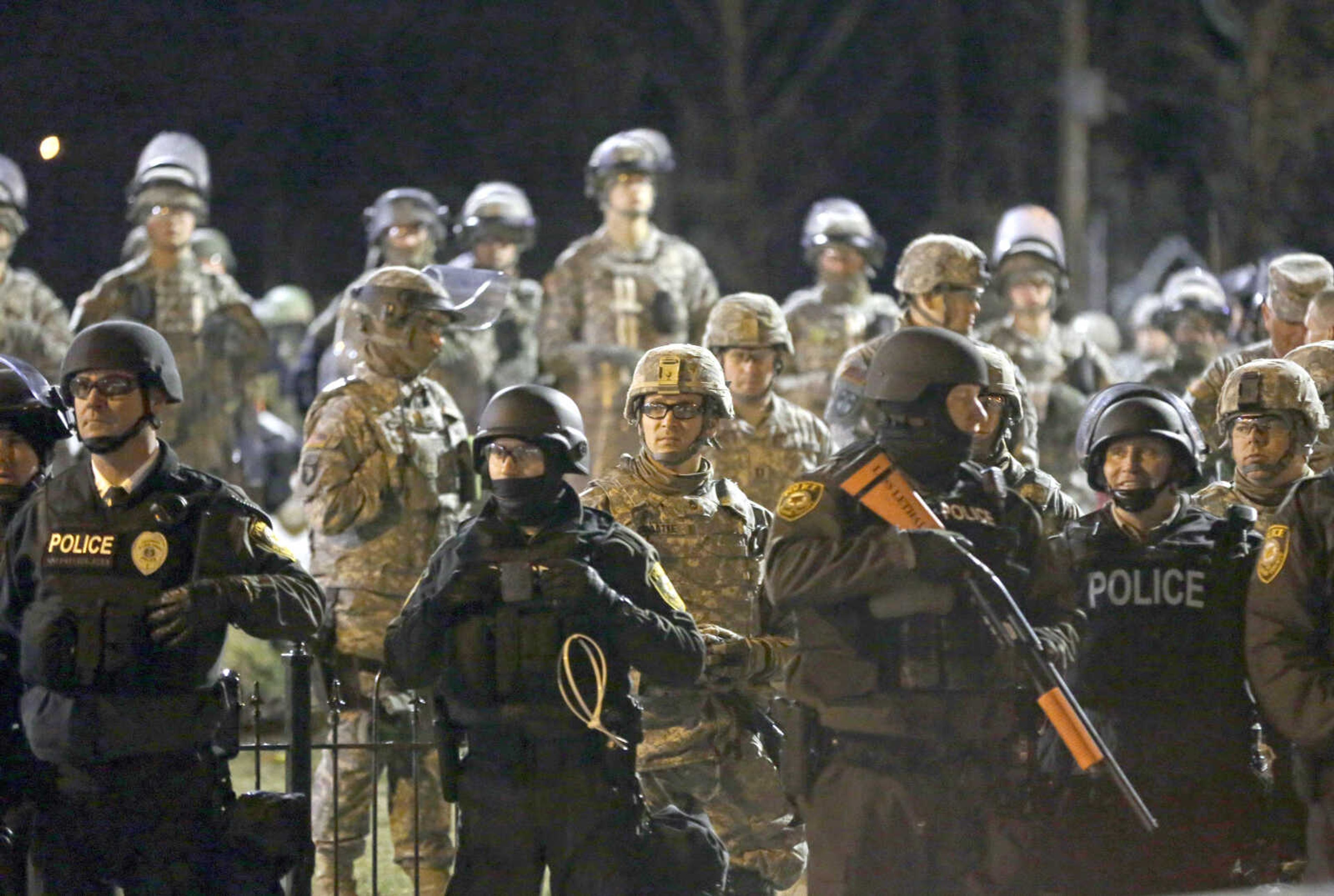 Police and Missouri National Guardsmen face protesters gathered in front of the Ferguson Police Department on Nov. 28, 2014, in Ferguson, Missouri.