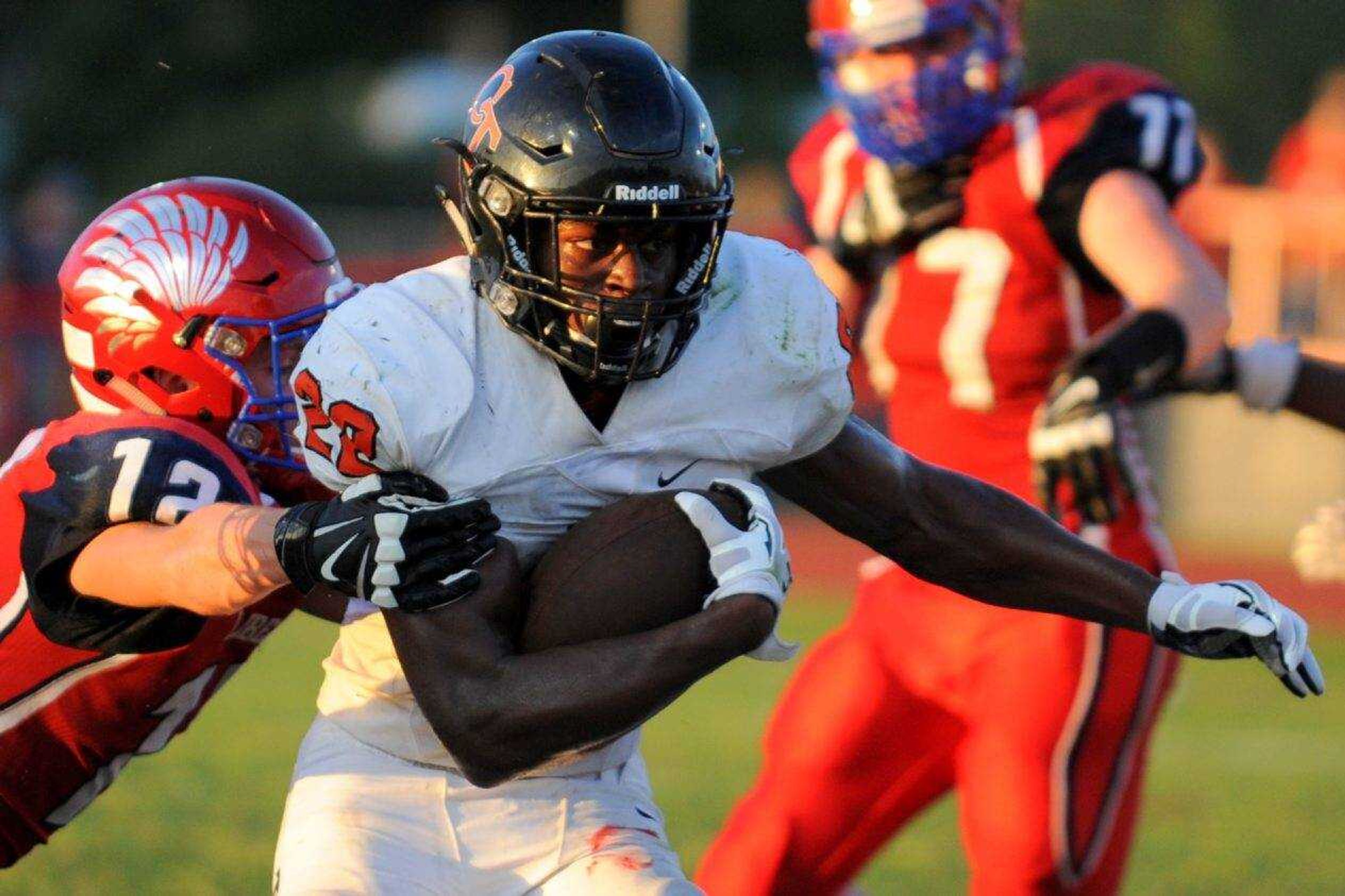 Cape Central's Aaron Harris carries the ball while Liberty's Andrew Holden attempts to tackle on Friday, Aug. 19, 2016 in Mountain View, Missouri.