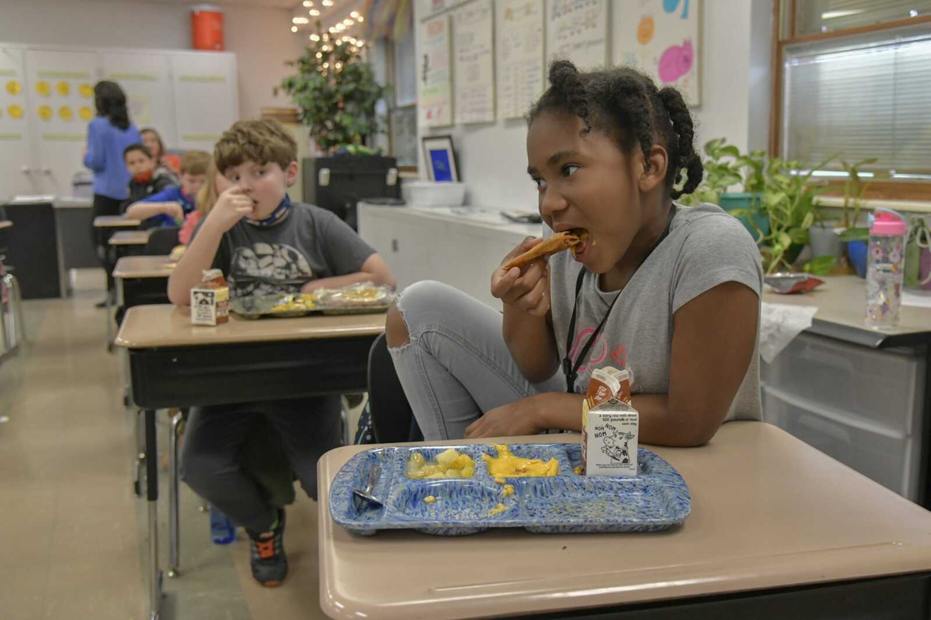 Third-grader Khloe Thomas eats a crispito for lunch at Alma Schrader Elementary School on Thursday in Cape Girardeau.