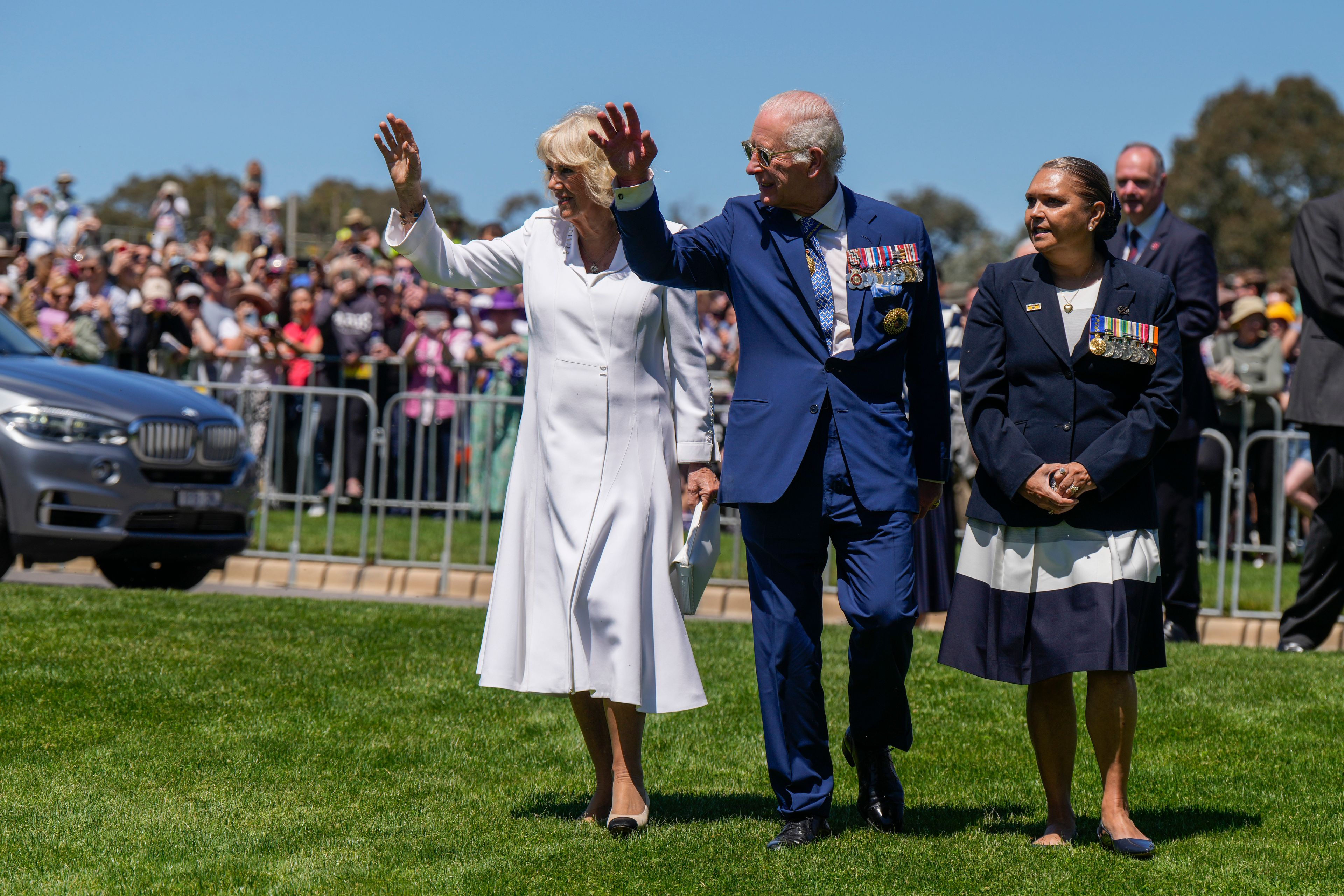 Britain's King Charles III, center, and Queen Camilla, left, waves at the Australian War Memorial in Canberra, Monday, Oct. 21, 2024. (AP Photo/Mark Baker, Pool)