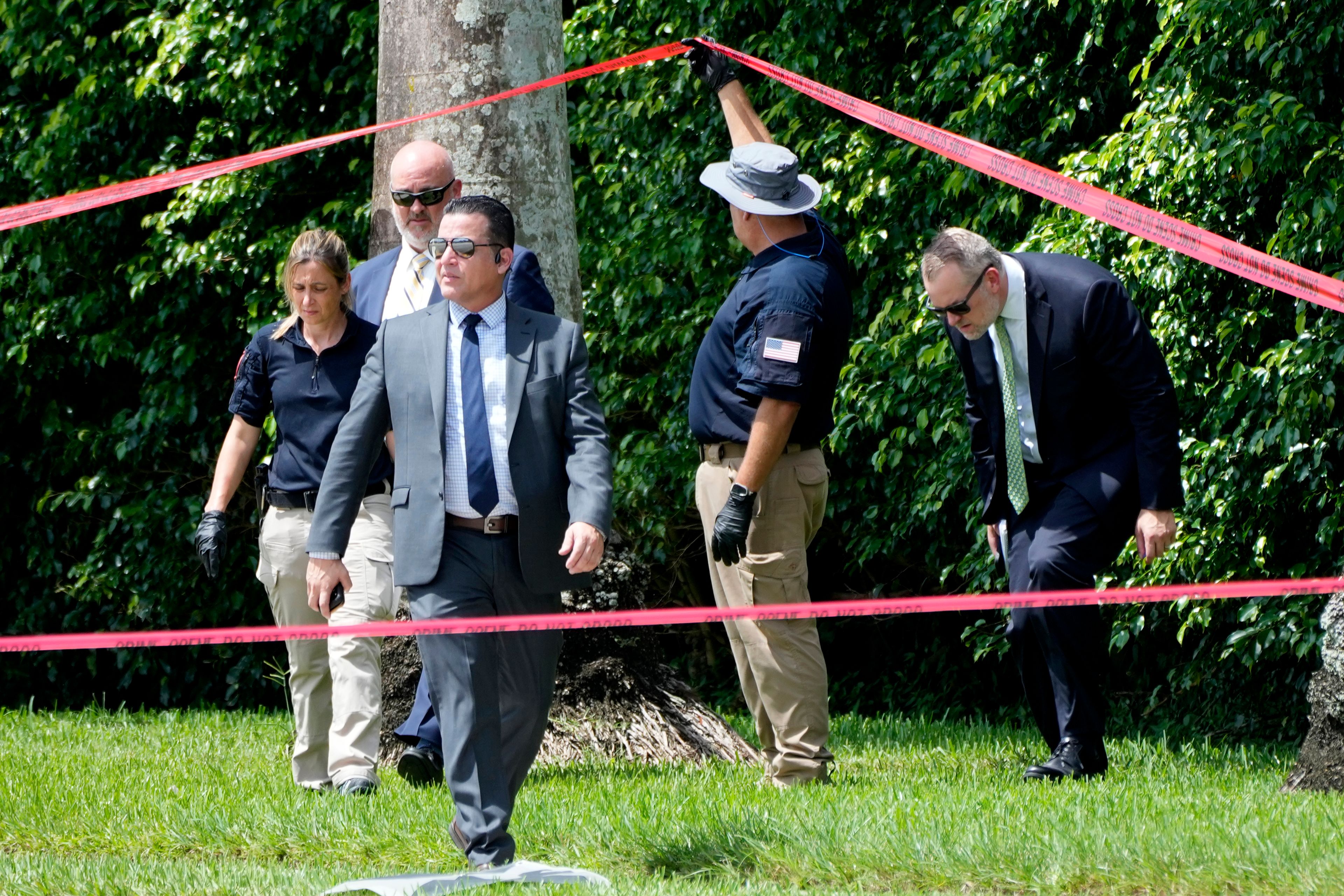 Law enforcement officials work outside of the Trump International Golf Club after the apparent assassination attempt of Republican presidential nominee and former President Donald Trump Monday, Sept. 16, 2024, in West Palm Beach, Fla. (AP Photo/Lynne Sladky)