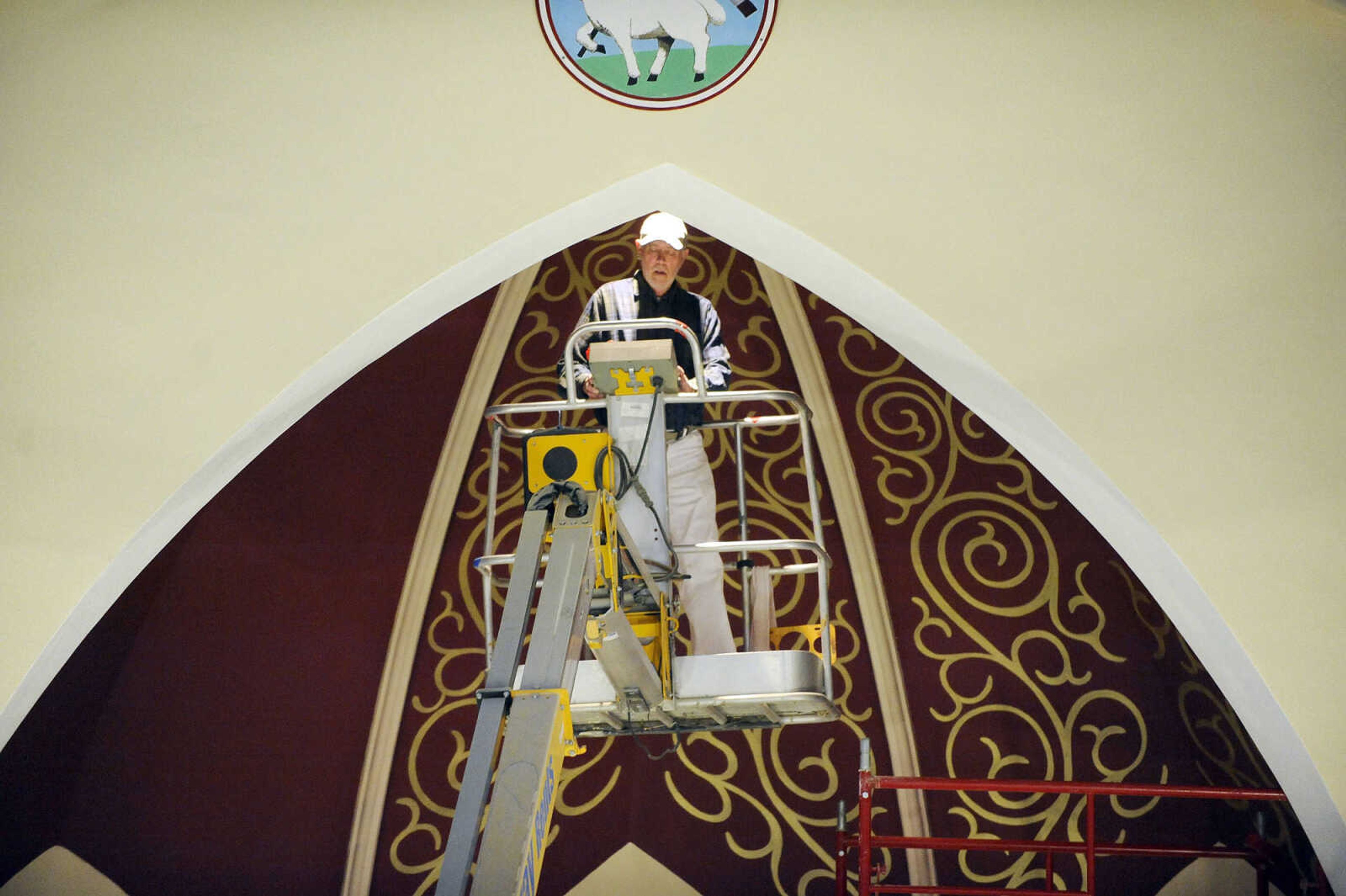 LAURA SIMON ~ lsimon@semissourian.com

Gary West heads up to the top of the ceiling in a cherry picker to work on the gold stenciling above the altar area of St. John's Catholic Church in Leopold, Missouri on March 4, 2016.