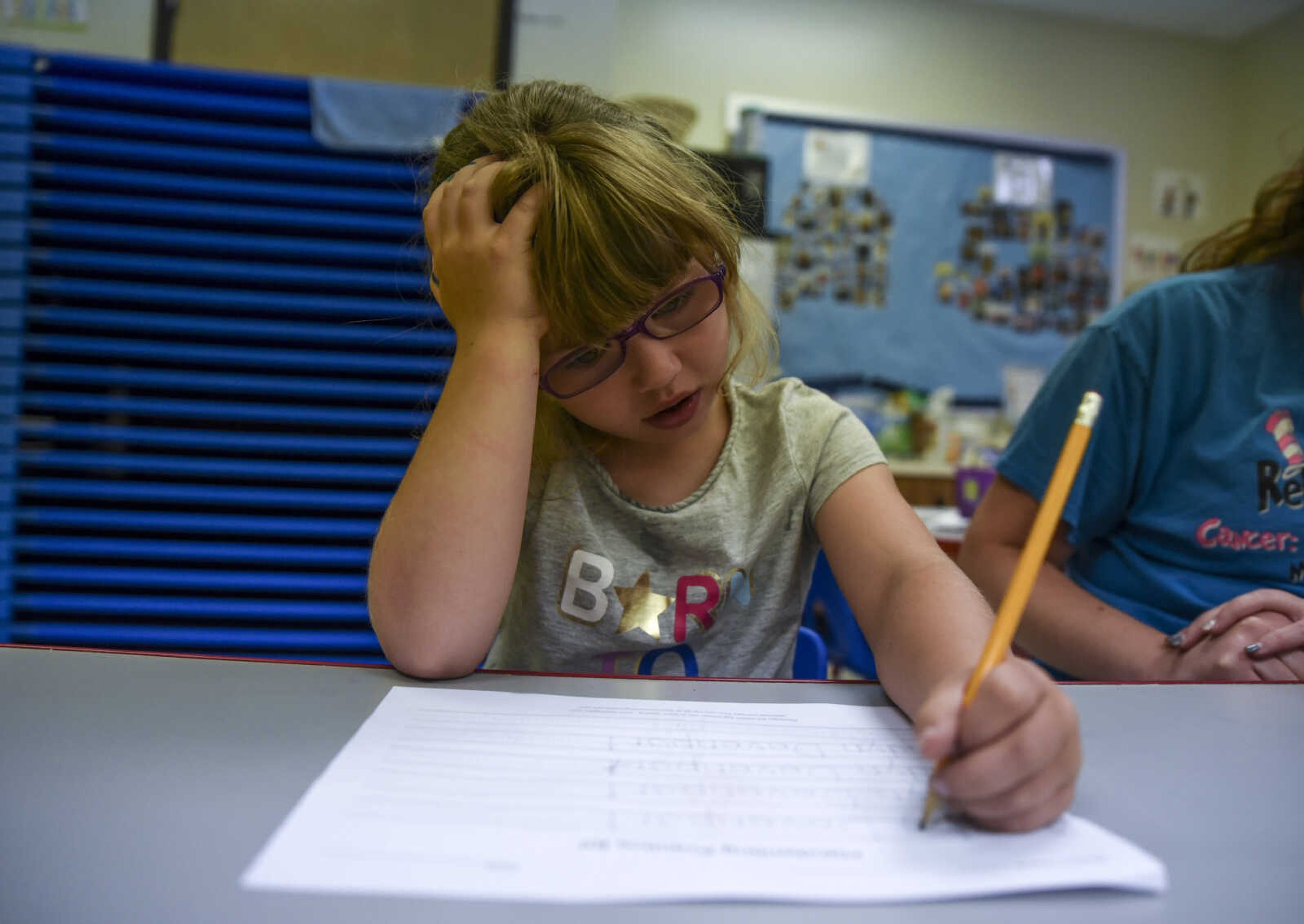 Lindyn Davenport, 6, practices writing her name during summer school at Woodland Elementary School Tuesday, June 5, 2018 in Marble Hill.