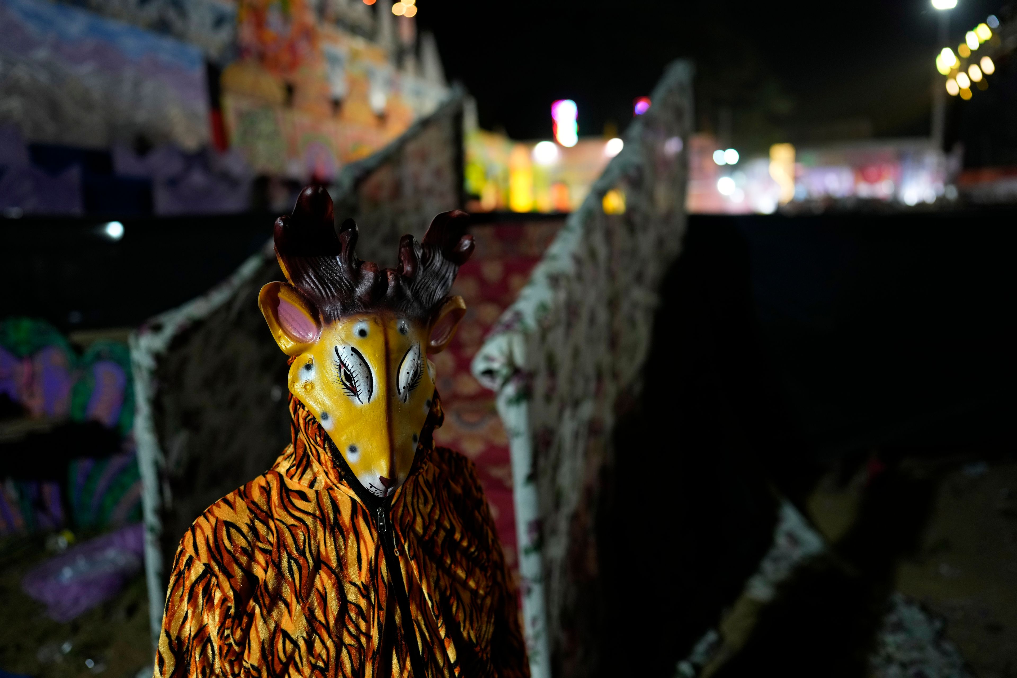 An actor dressed as a deer waits for the cue to go onstage during Ramleela, a dramatic folk re-enactment of the life of Hindu god Rama according to the ancient Hindu epic Ramayana, in New Delhi, India, Wednesday, Oct. 9, 2024. (AP Photo/Manish Swarup)