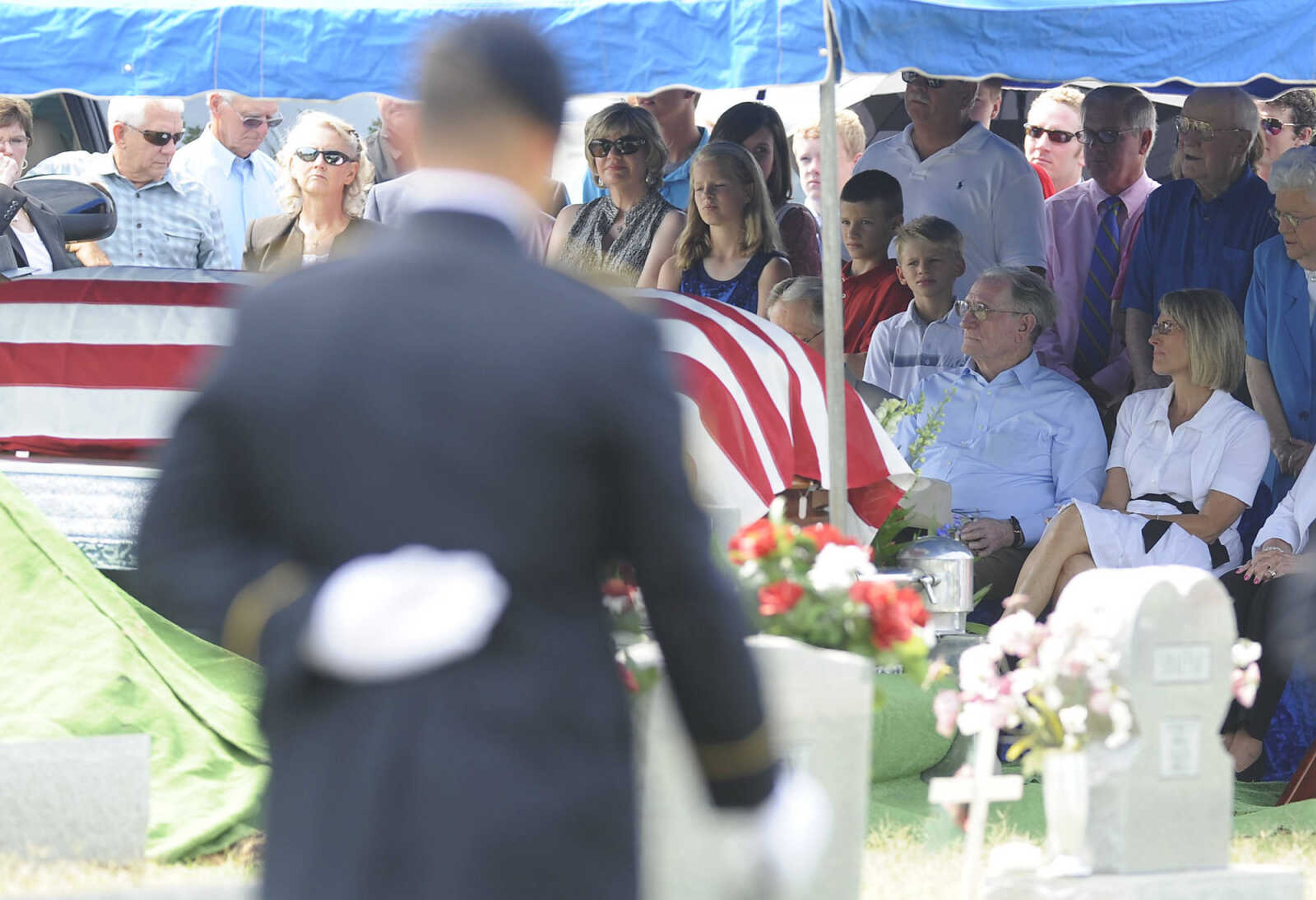 Friends and family look on during the funeral for U.S. Army Air Forces 1st Lt. Warren G. Moxley Tuesday, July 3, at the Odd Fellows Cemetery in Charleston, Mo. A pilot with the 67th Tactical Recon Group's 107th Observation Squadron Moxley was killed on March 15, 1945, when his F6, a photo-reconnaissance model of the P-51 Mustang, was shot down over Germany by anti-aircraft fire. His remains were identified using DNA earlier this year.