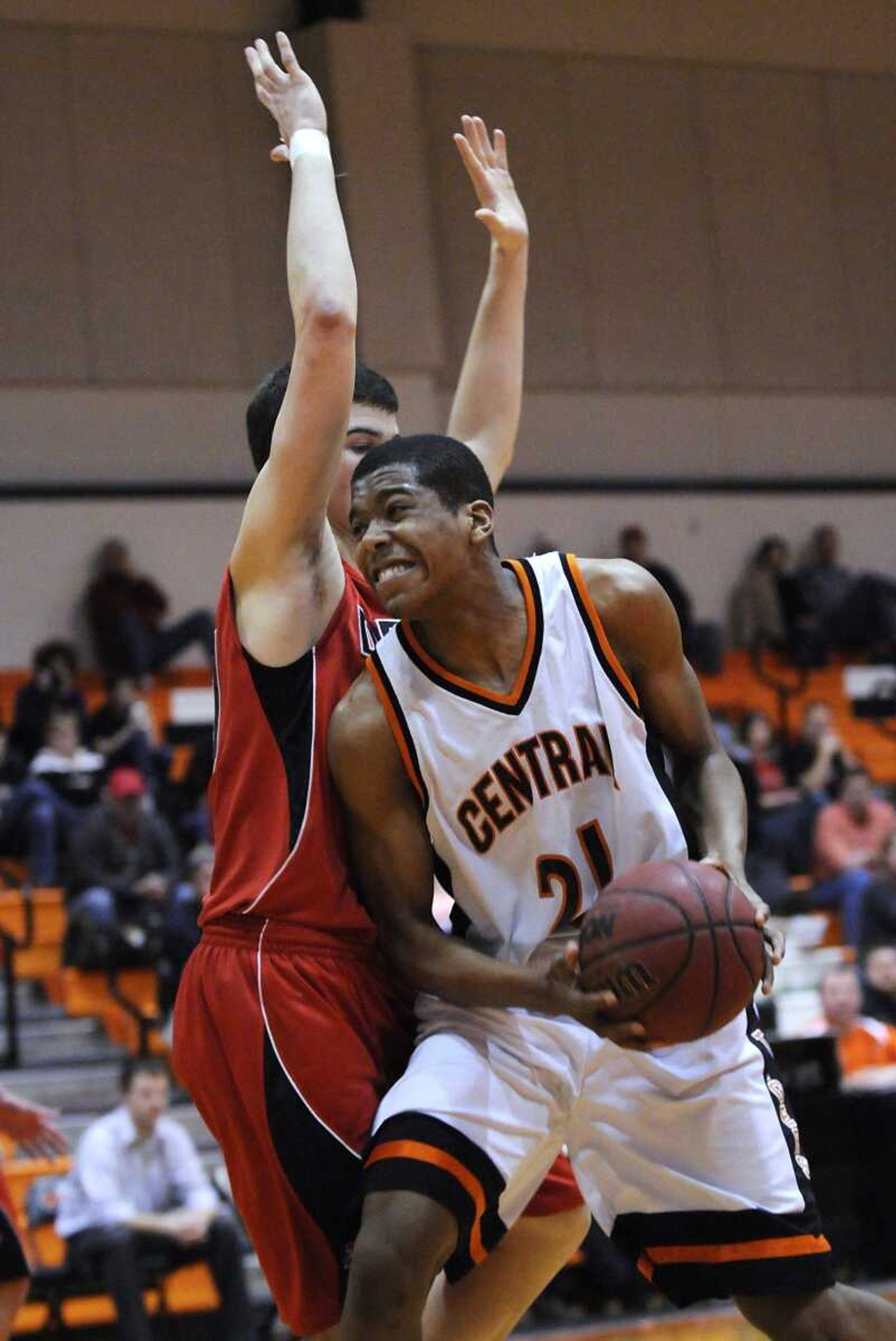 Central's T.J. Tisdell maneuvers toward the basket around Dexter's Alan Flannigan during the first quarter Friday.