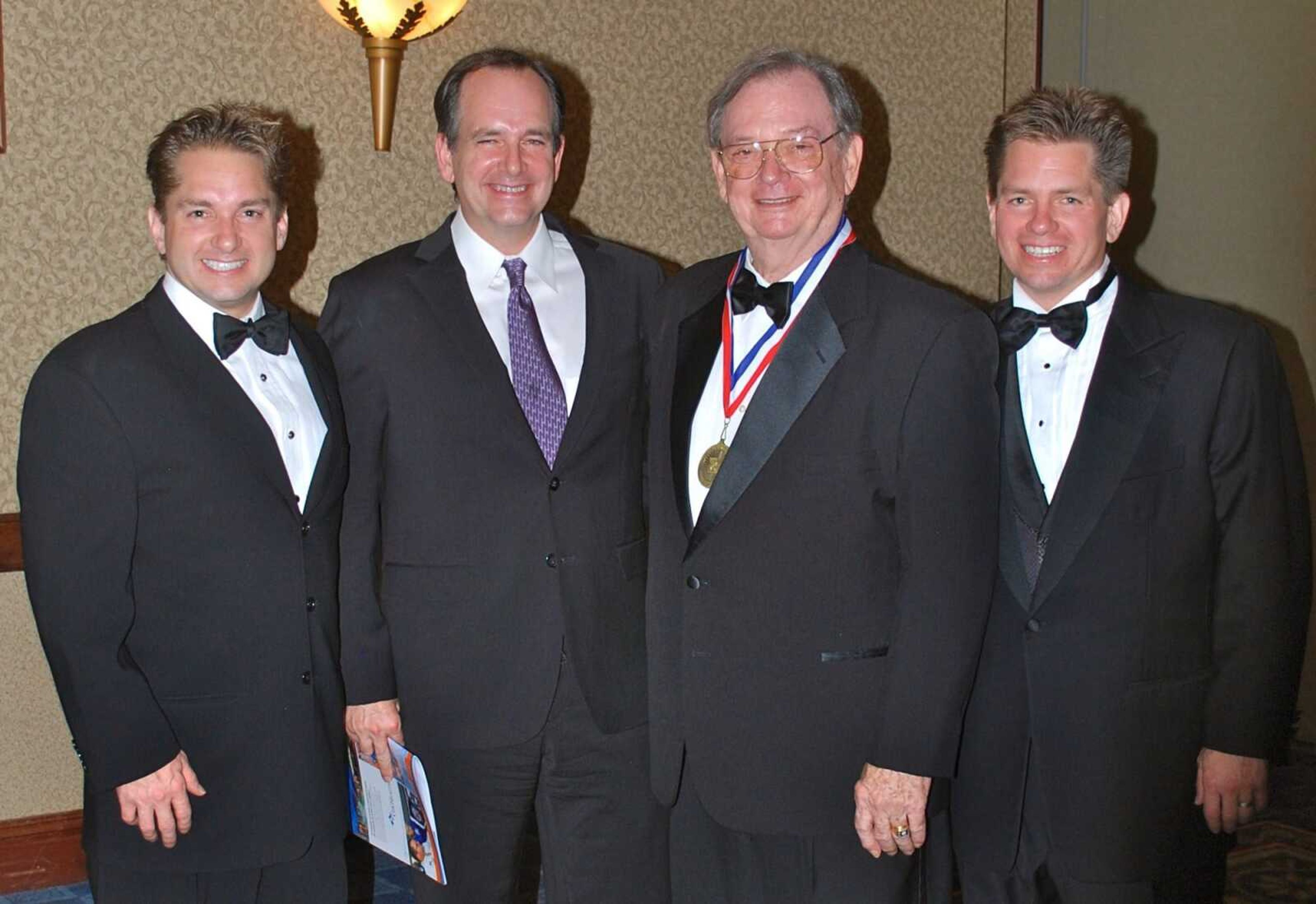 Rex Rust, right, attends a black-tie ceremony honoring his father in Jefferson City, Sept. 17, 2011. Also pictured are, from left, Jon K.Rust, Gary Rust II and Gary W. Rust.