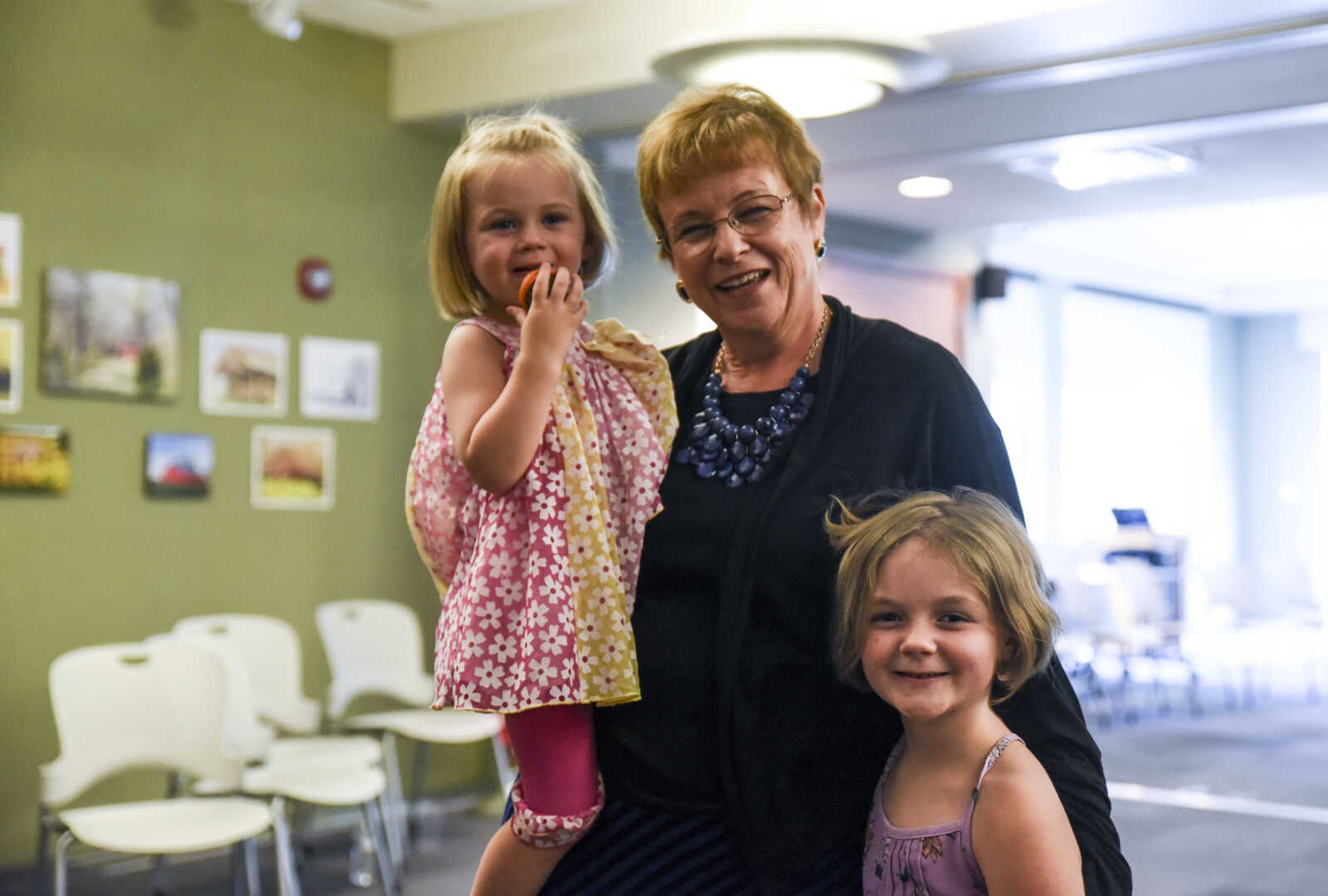 Betty Martin poses for a photo with her granddaughters Melody Murad, 2, and Lily Murad, 7, at her retirement open house Friday, July 13, 2018 at the Cape Girardeau Public Library.