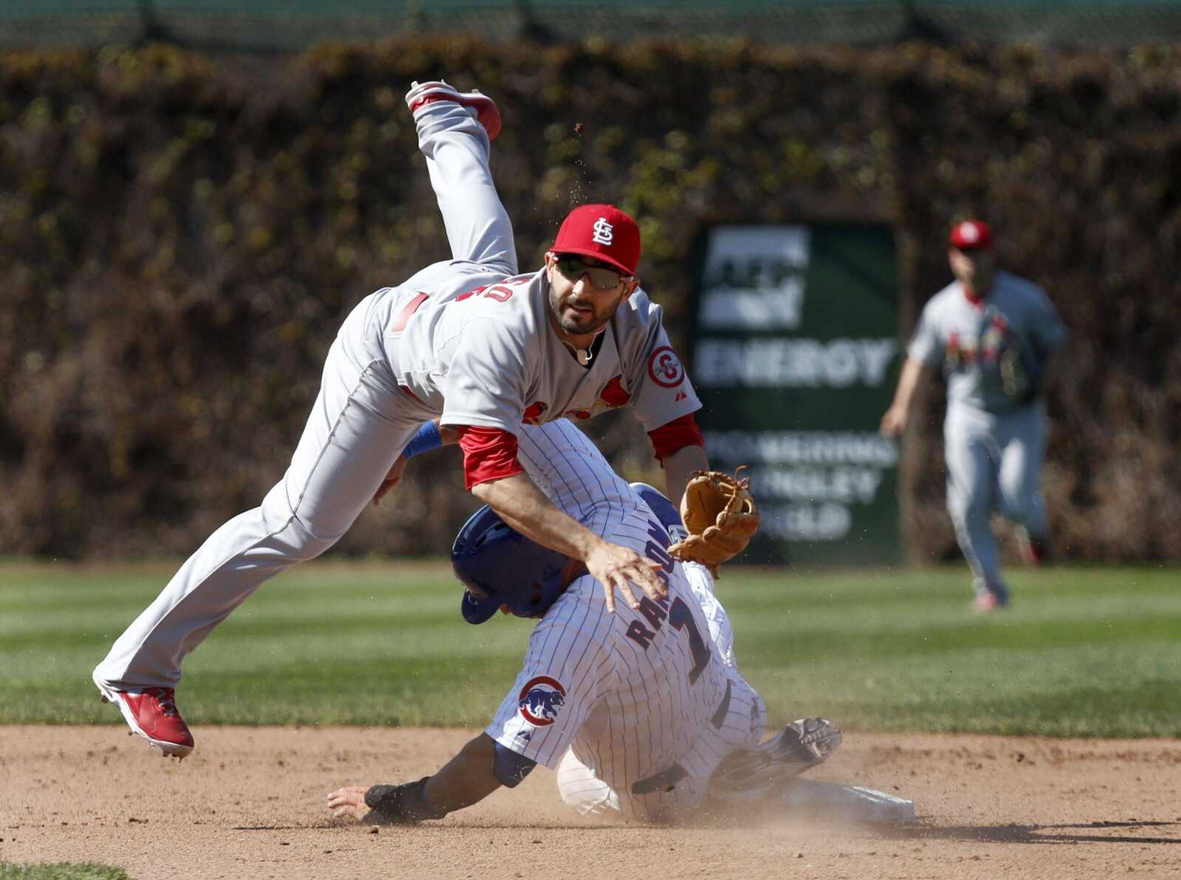 Cardinals second baseman Daniel Descalso turns the double play after forcing the Cubs&#8217; Cody Ransom at second during the seventh inning. (Charles Rex Arbogast ~ Associated Press)