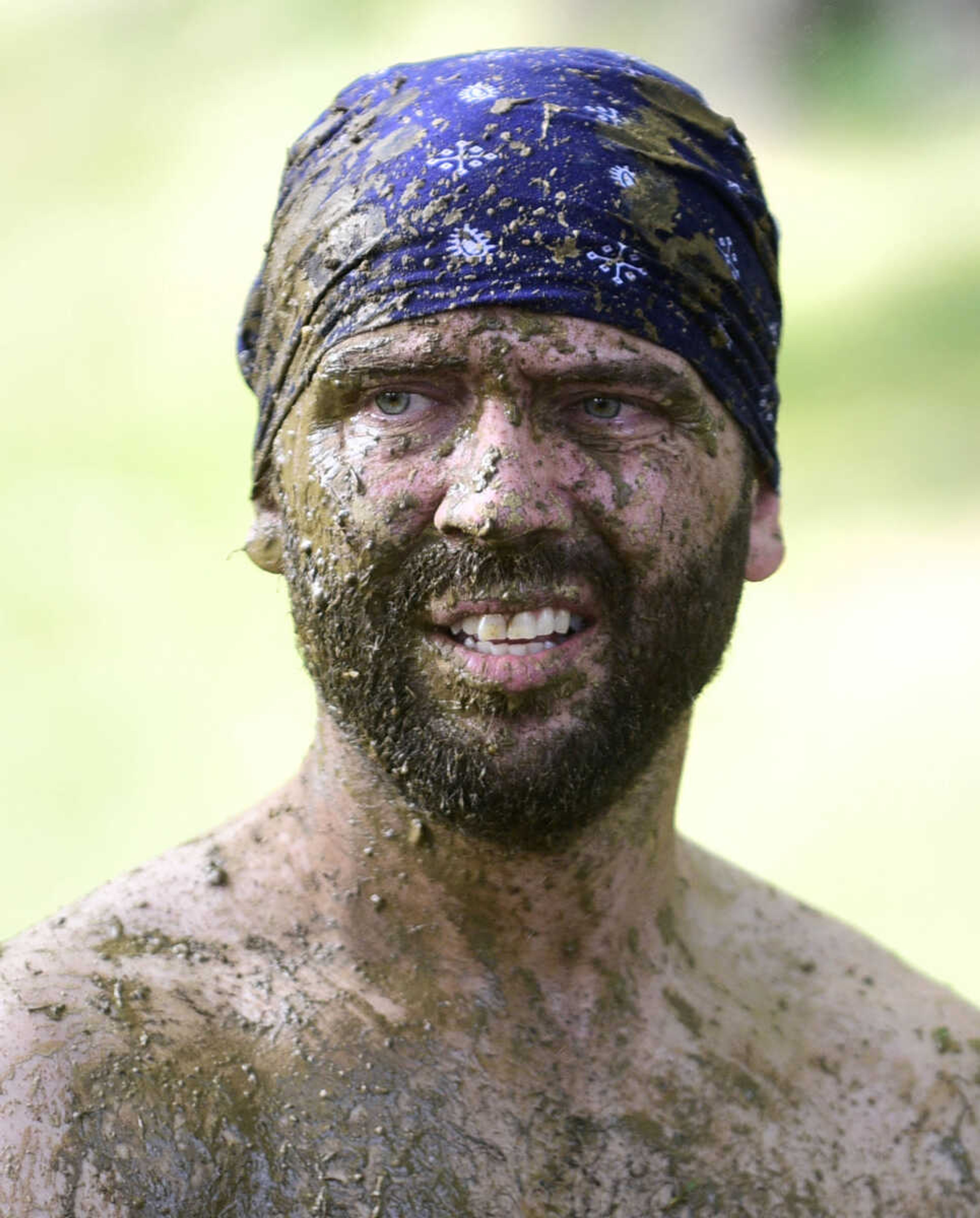 Team members hit the wash station after playing mud volleyball during the Fourth of July celebration on Tuesday at Jackson City Park.