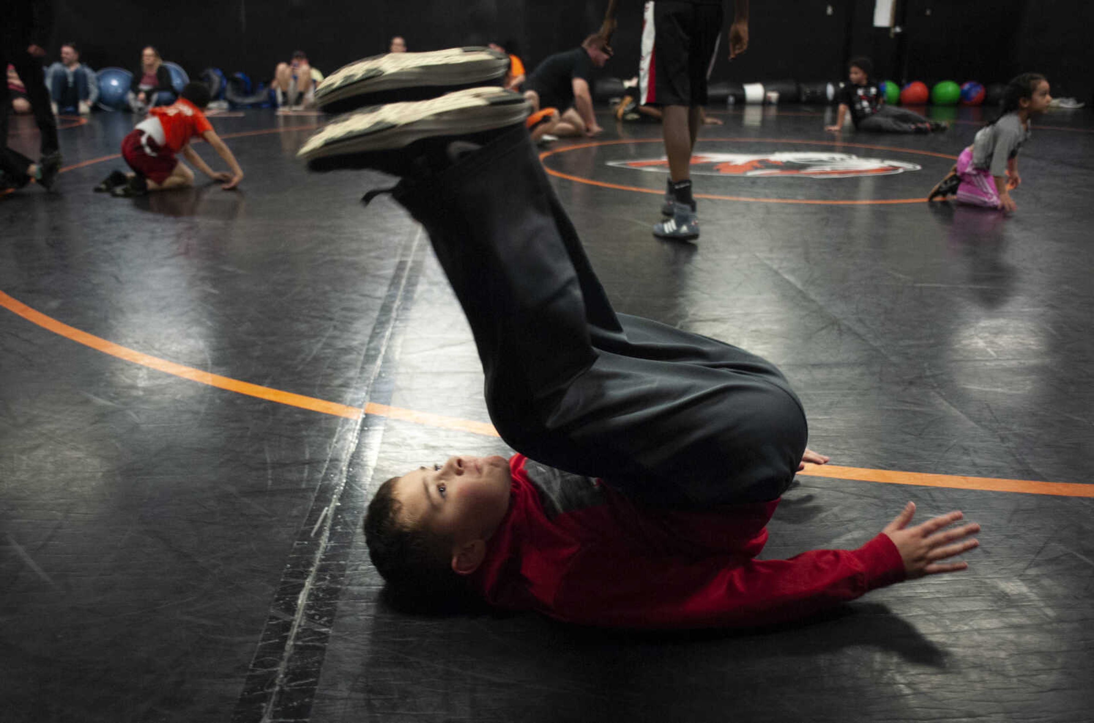 Holden Covington of Cape Girardeau, 8, executes an exercise while practicing with Cape Girardeau Little League Wrestling on Thursday, March 7, 2019, at Cape Central High School.