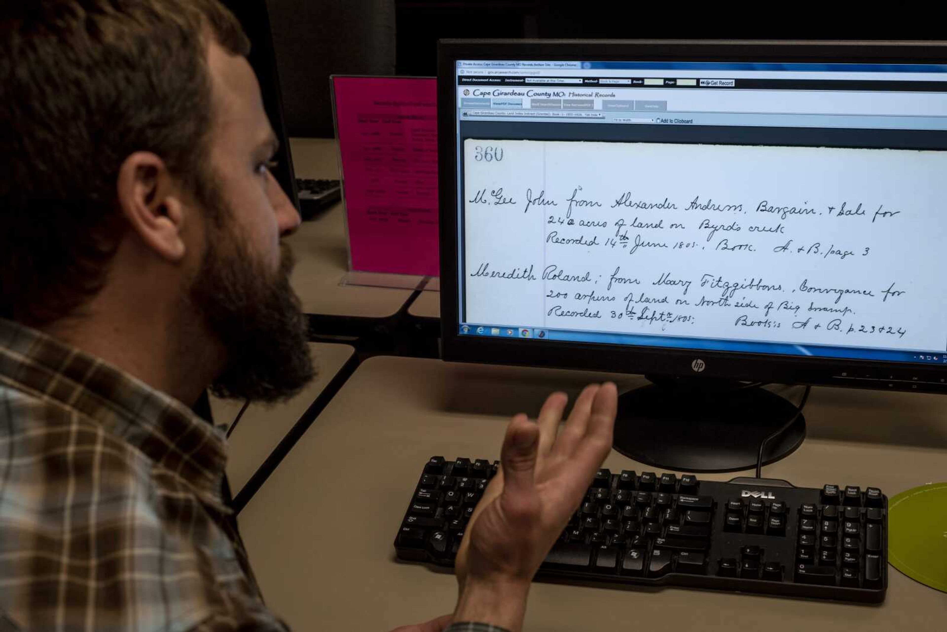 Cape Girardeau County Recorder Drew Blattner shows digitized scans of the deed index books Thursday at the Recorder of Deeds Office at the Cape Girardeau Administration Building in Jackson. The aging books were recently digitized.