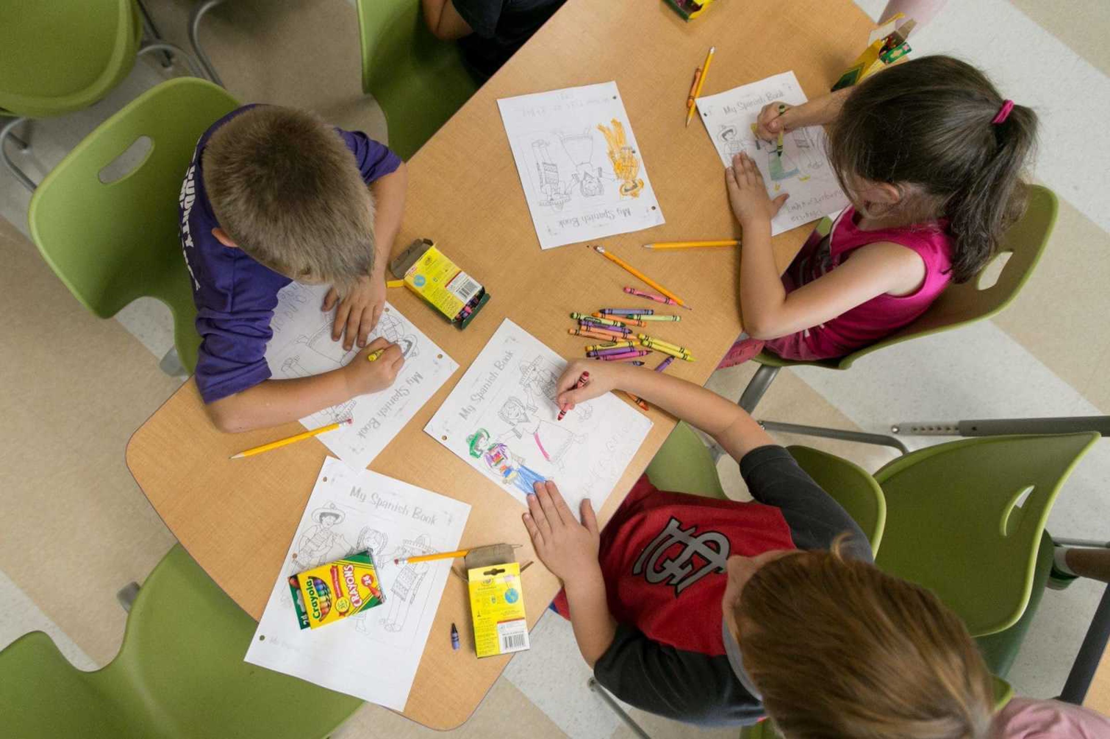 A group of students colors their Spanish workbooks during class for the Jackson Summer Adventure Club on June 5, 2016, at East Elementary.