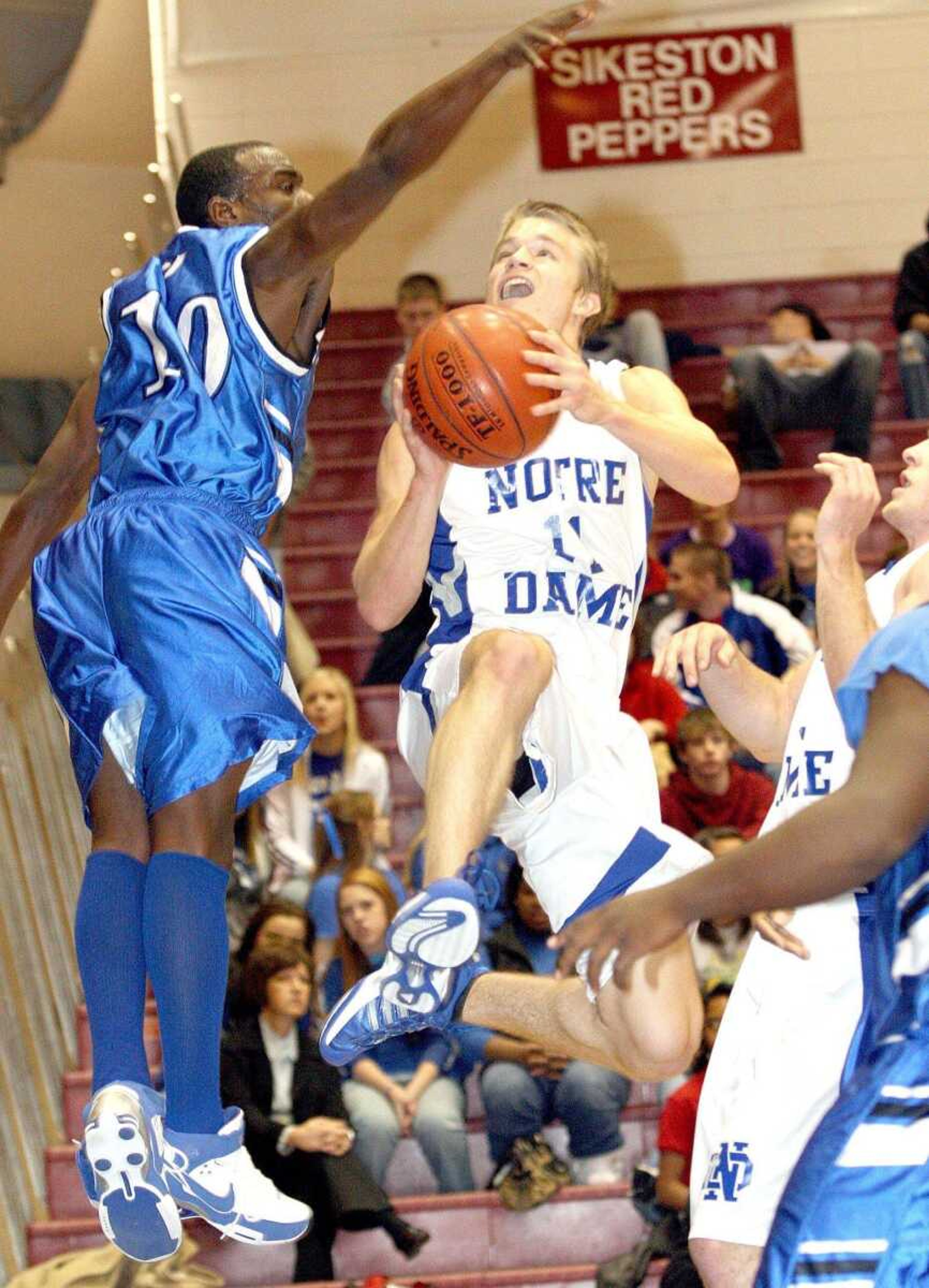 Notre Dame's Ty Williams tried to put up a shot around Charleston's Antonio Riggens during Thursday's semifinal game at the SEMO Conference tournament in Sikeston. (DAVID JENKINS ~ Sikeston Standard Democrat)