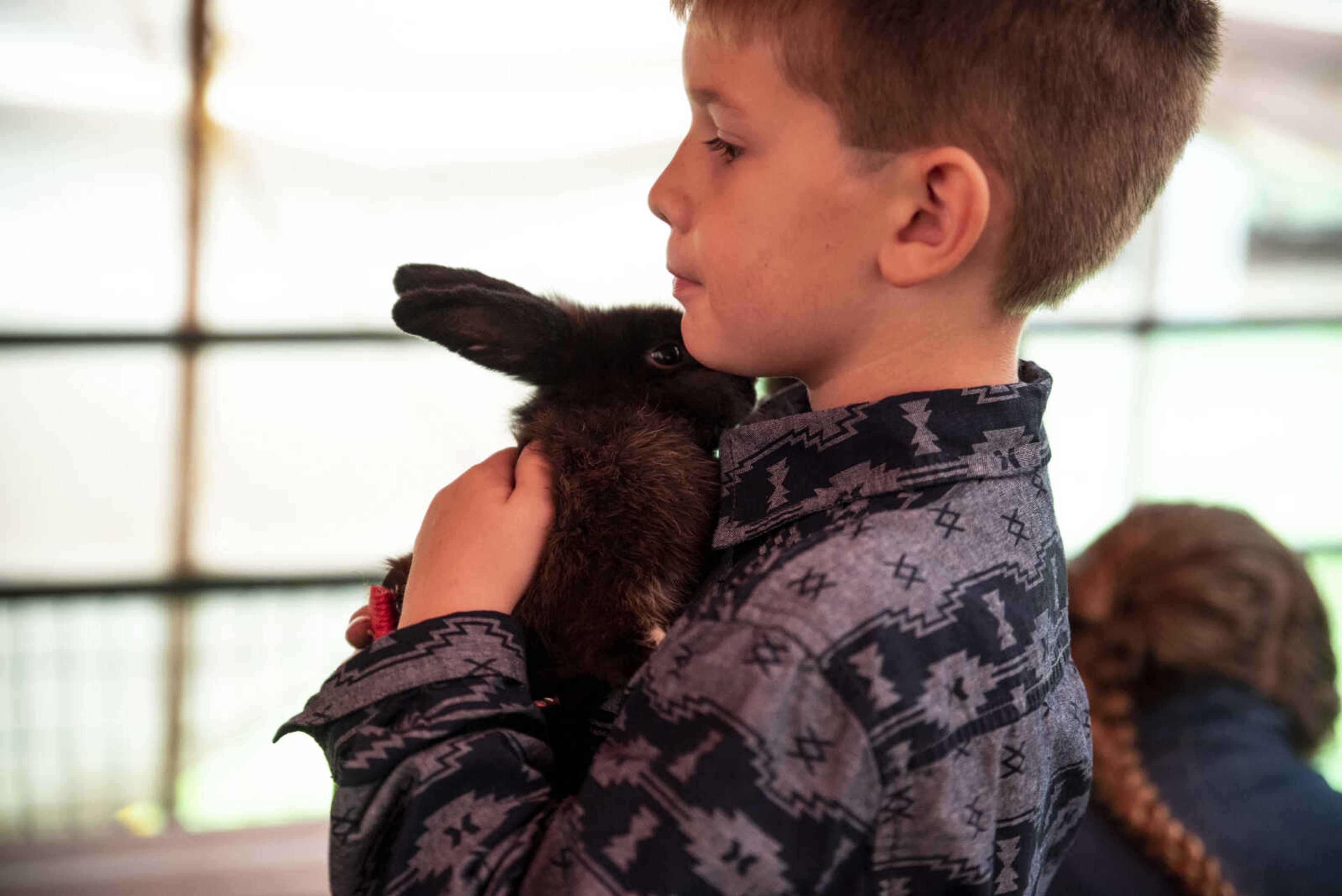 Elijah Standley, 6, holds his rabbit Chip, dressed as Zoro, before the start of the Poultry and Rabbit Dress-Up Contest at the SEMO District Fair Sunday, Sept. 9, 2018 in Cape Girardeau.