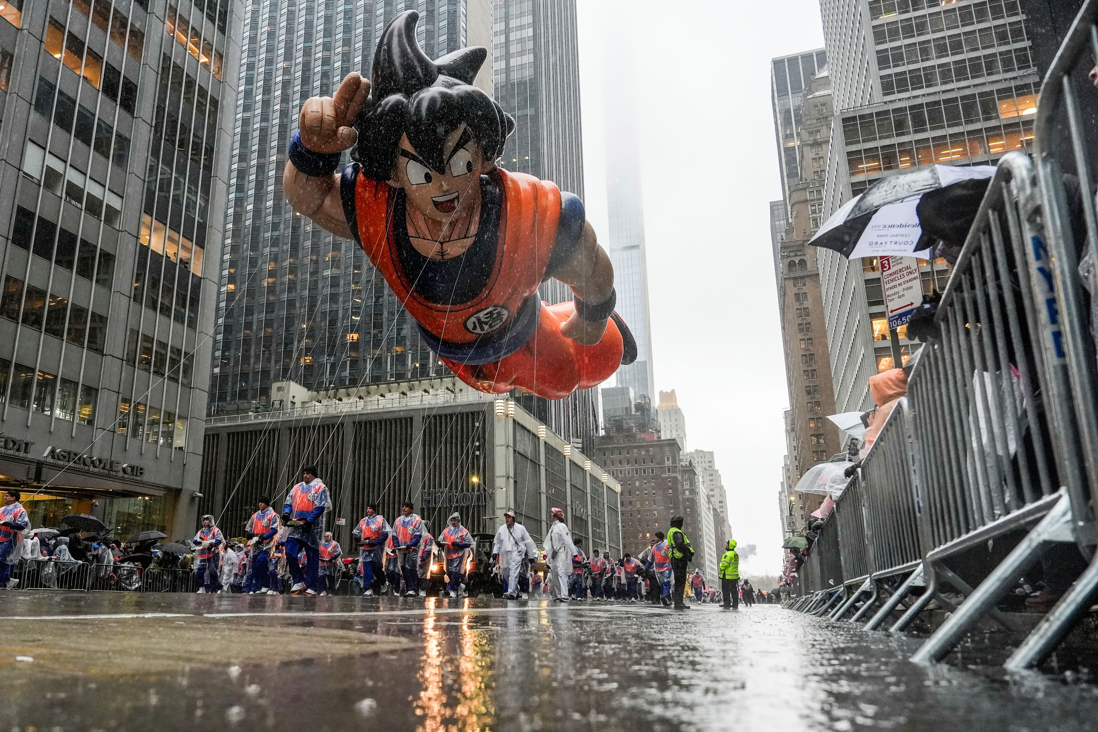 Handlers guide the Goku balloon down Sixth Avenue during the Macy's Thanksgiving Day Parade, Thursday, Nov. 28, 2024, in New York. (AP Photo/Julia Demaree Nikhinson)