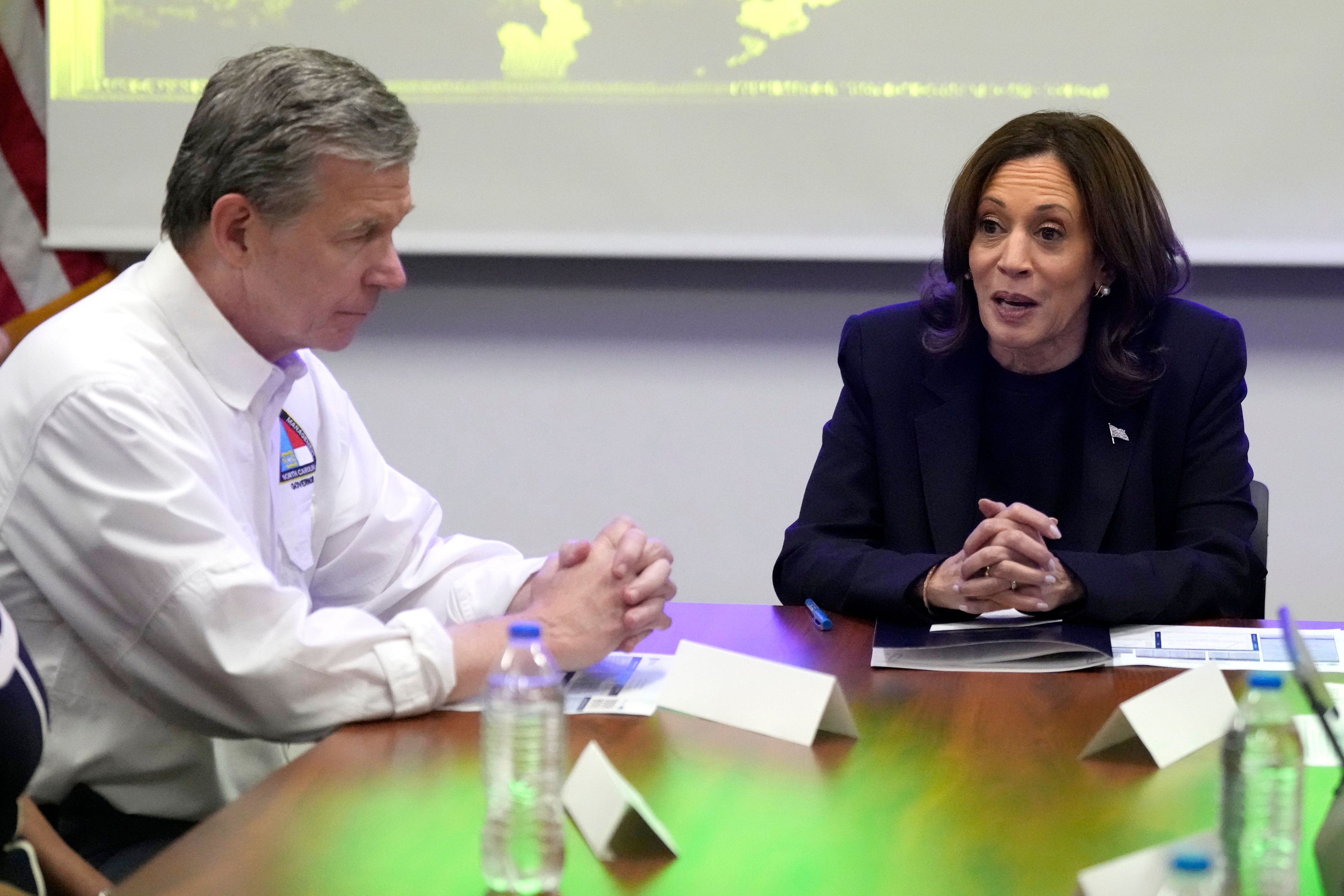 Democratic presidential nominee Vice President Kamala Harris, right, receives a briefing from North Carolina Gov. Roy Cooper on the damage from Hurricane Helene, Saturday, October 5, 2024 in Charlotte, N.C. (AP Photo/Chris Carlson)