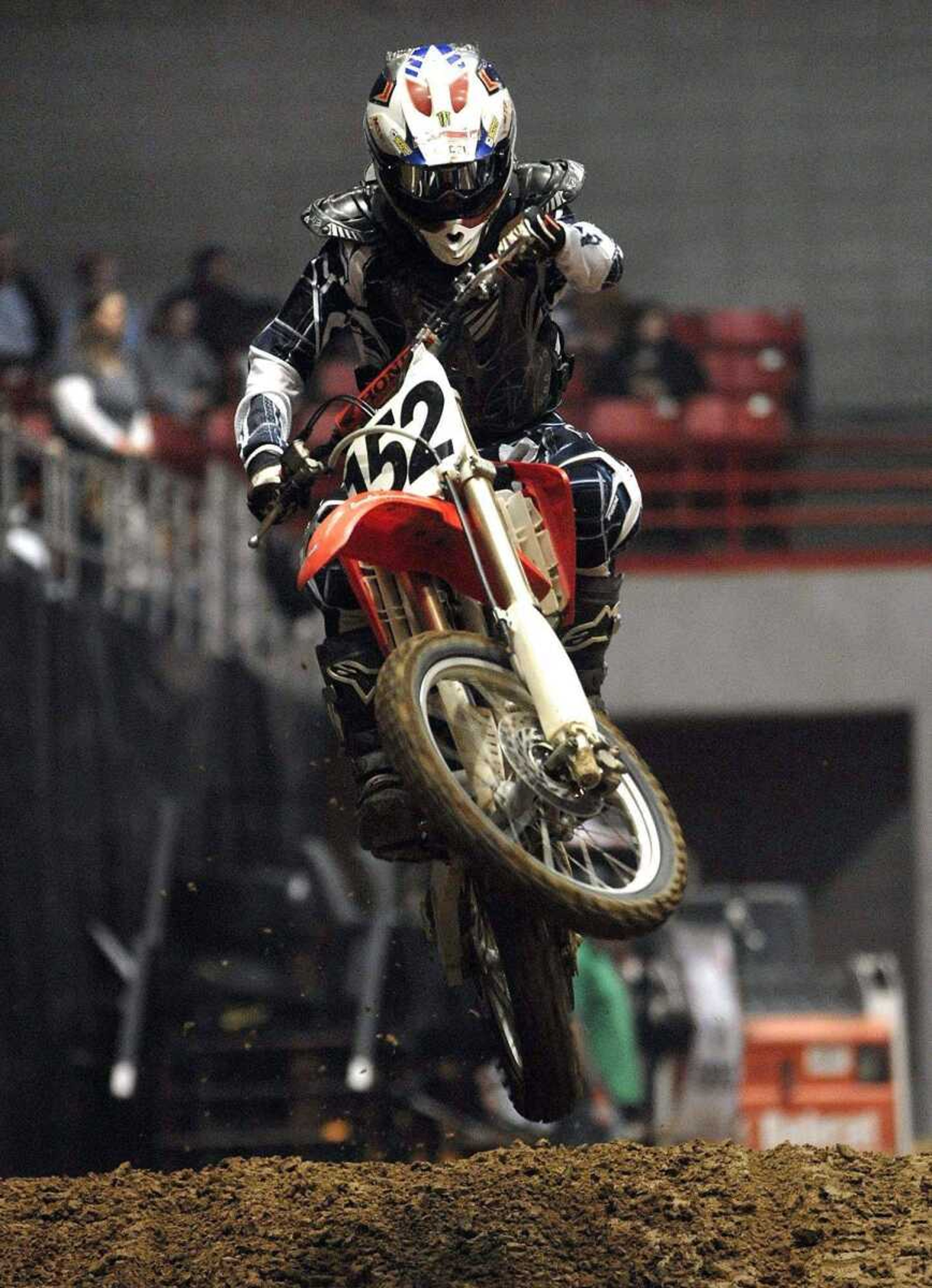 Dillon Myers of Oak Ridge, Mo., jumps his motocross bike between monster truck races Friday night at the Show Me Center.