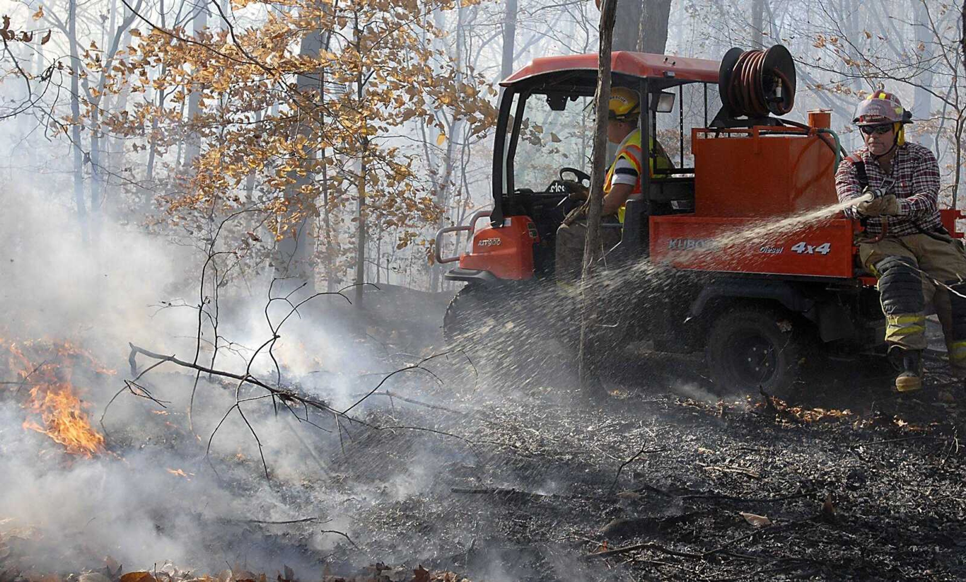 KIT DOYLE ~ kdoyle@semissourian.com
Firefighters put out a brush fire from a Kubota ATV Wednesday,  November 11, 2009, in the Juden Creek Conservation Area.  Assistant chief Mark Hasheider called the five-acre burn suspicious with a similar burn occurring Tuesday evening in the same area.  The brush fire was in a remote location in difficult terrain for personnel and equipment to reach.