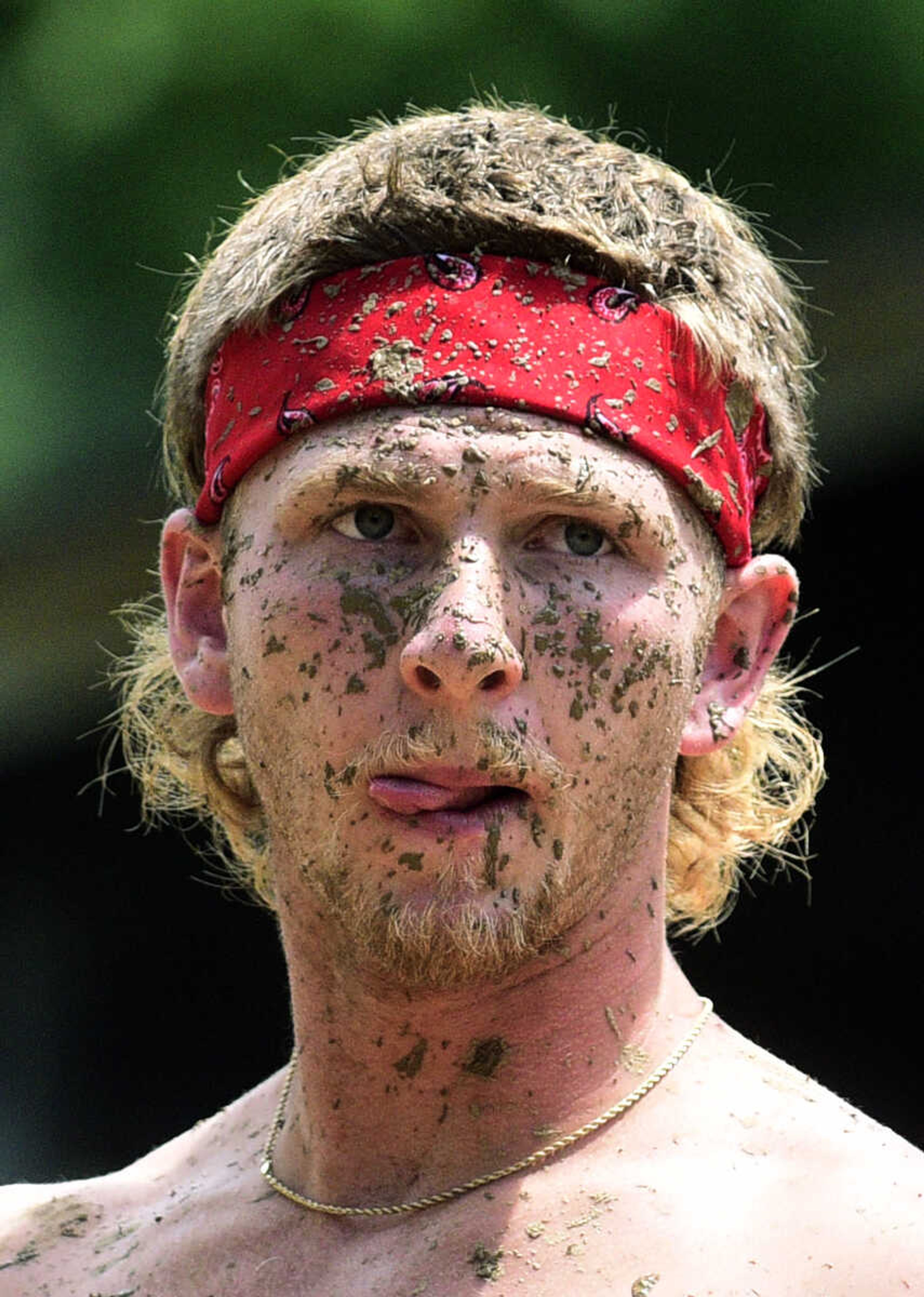 Mud covers team members as they play mud volleyball during the Fourth of July celebration on Tuesday at Jackson City Park.