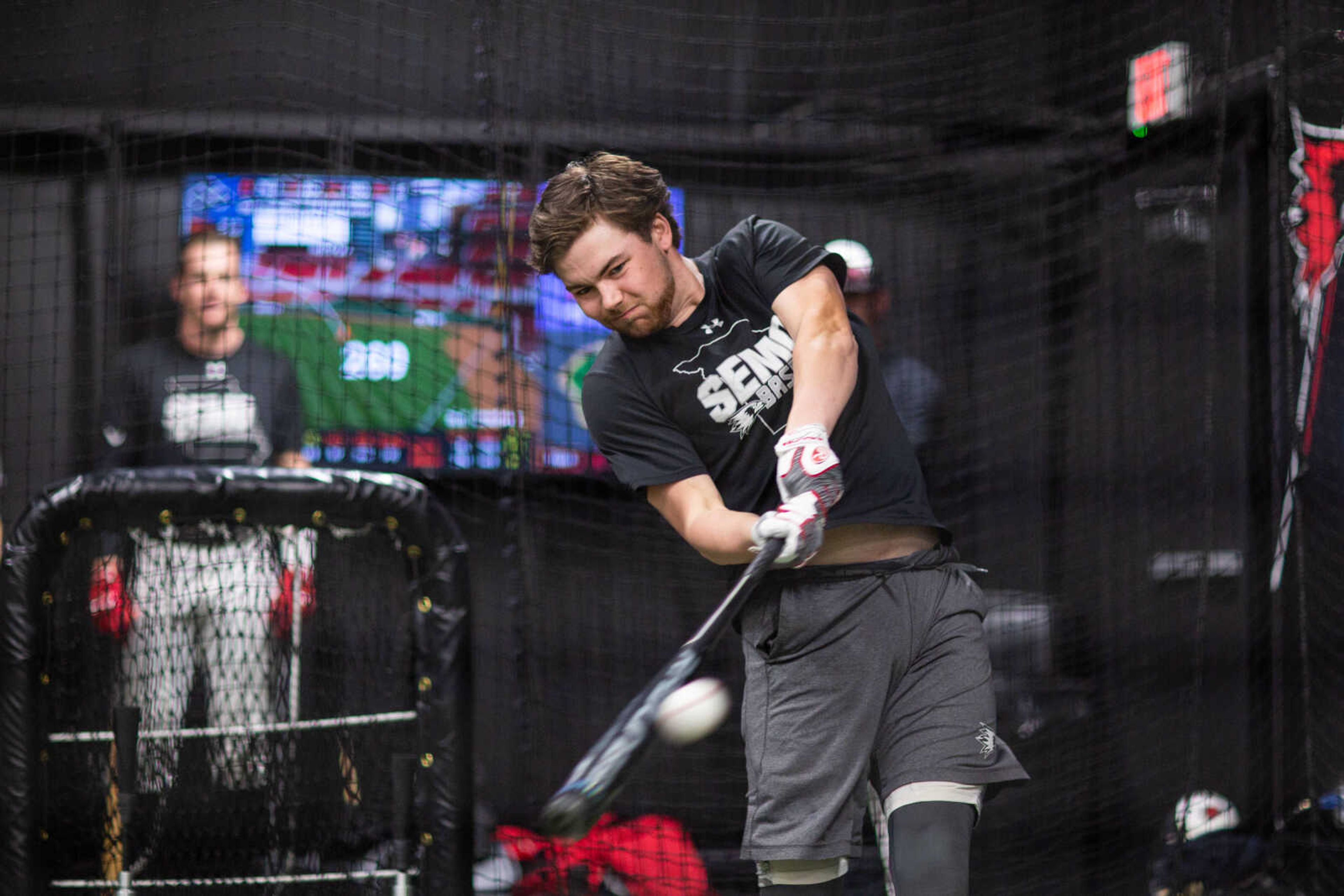 Andrew Keck takes hitting practice as information on his hits are displayed on a screen behind him at the Southeast baseball team's indoor training facility at Capaha Park on Tuesday, February 11, 2020.