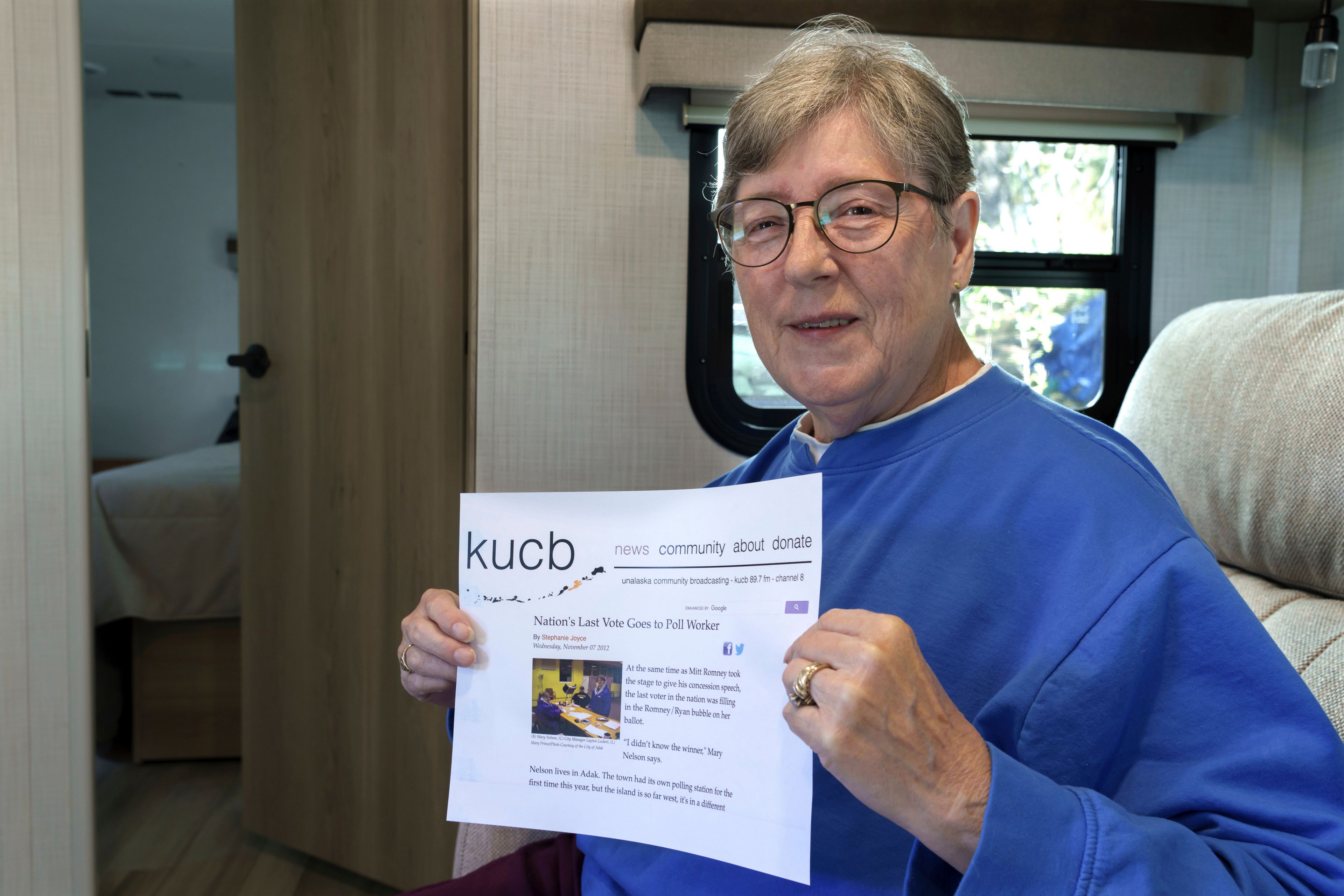 Mary Nelson, of Mead, Wash., near Spokane, Wash., poses for a photo at her home on Wednesday, Oct. 2, 2024. Nelson is holding a printout of a radio station website news story that says she is thought to be the last person in the U.S. to cast a vote in the 2012 presidential election when she voted for Mitt Romney just before the polls closed in the remote village of Adak, Alaska. (AP Photo/Ted S. Warren)