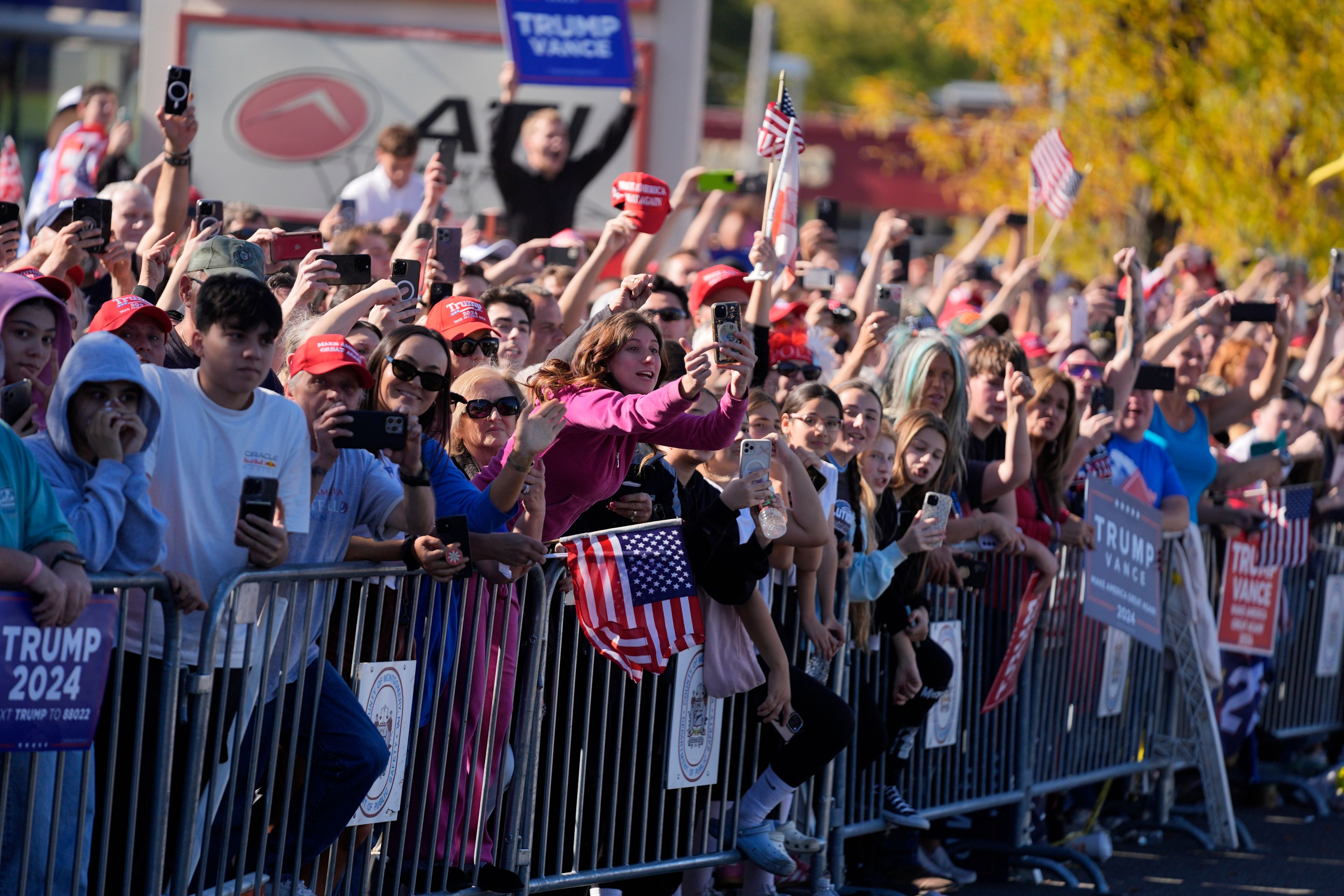 Supporters of Republican presidential nominee former President Donald Trump cheer outside of a McDonald's in Feasterville-Trevose, Pa., after Trump made a campaign stop, Sunday, Oct. 20, 2024, (AP Photo/Evan Vucci)