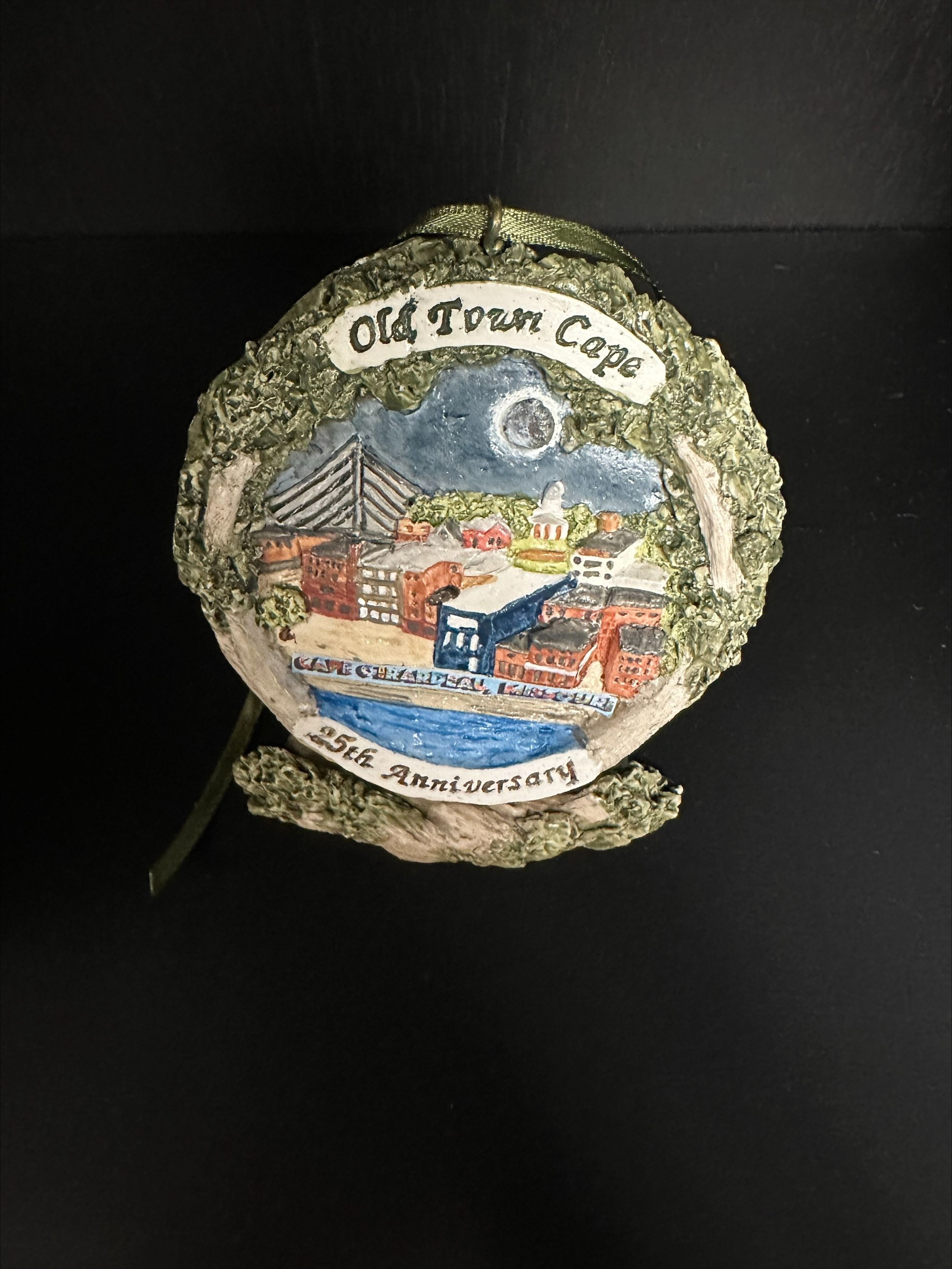 This year’s Old Town Cape ornament is the 25th-anniversary edition. It captures “the amazing Eclipse event as well as the essence of the downtown community and Old Town Cape projects such as the mural on the river wall”