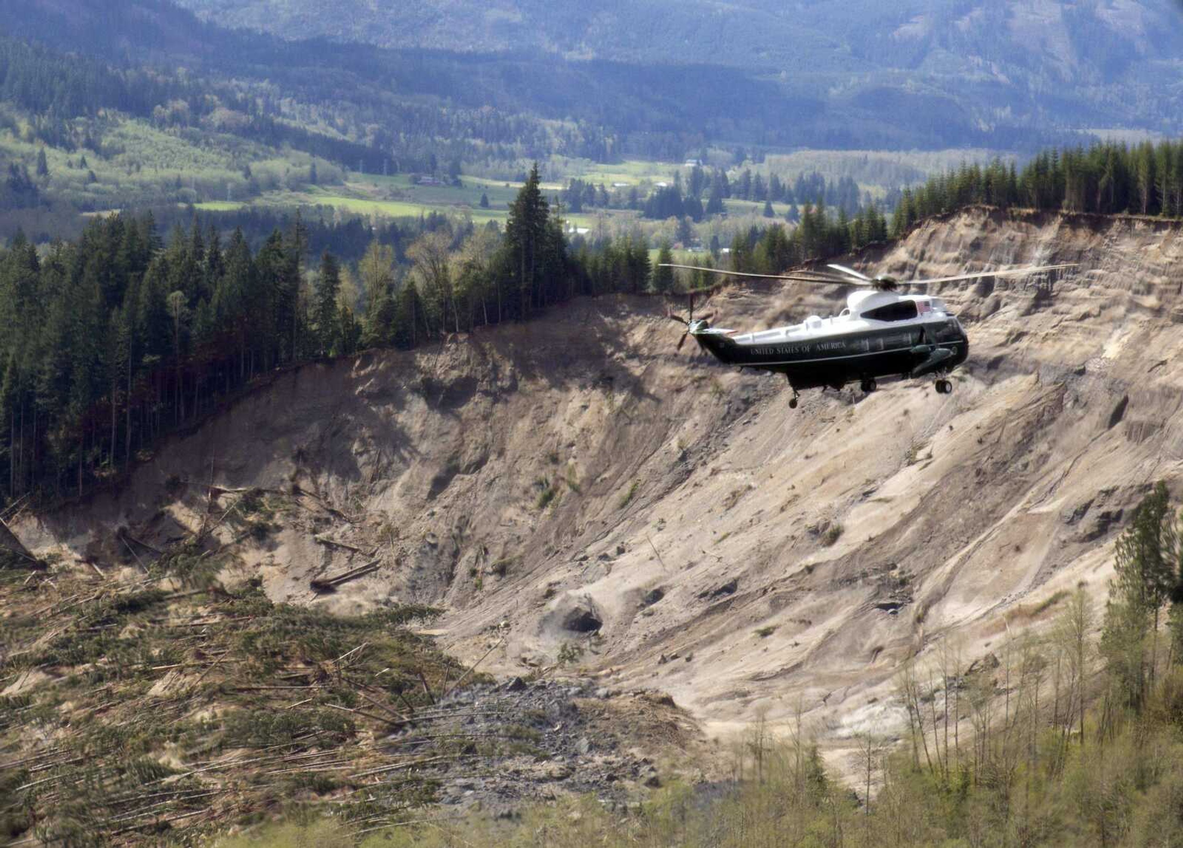 Marine One helicopter, carrying President Barack Obama, takes an aerial tour Tuesday of Oso, Wash., above the site of the deadly mudslide that struck the community in March. (Carolyn Kaster ~ Associated Press)