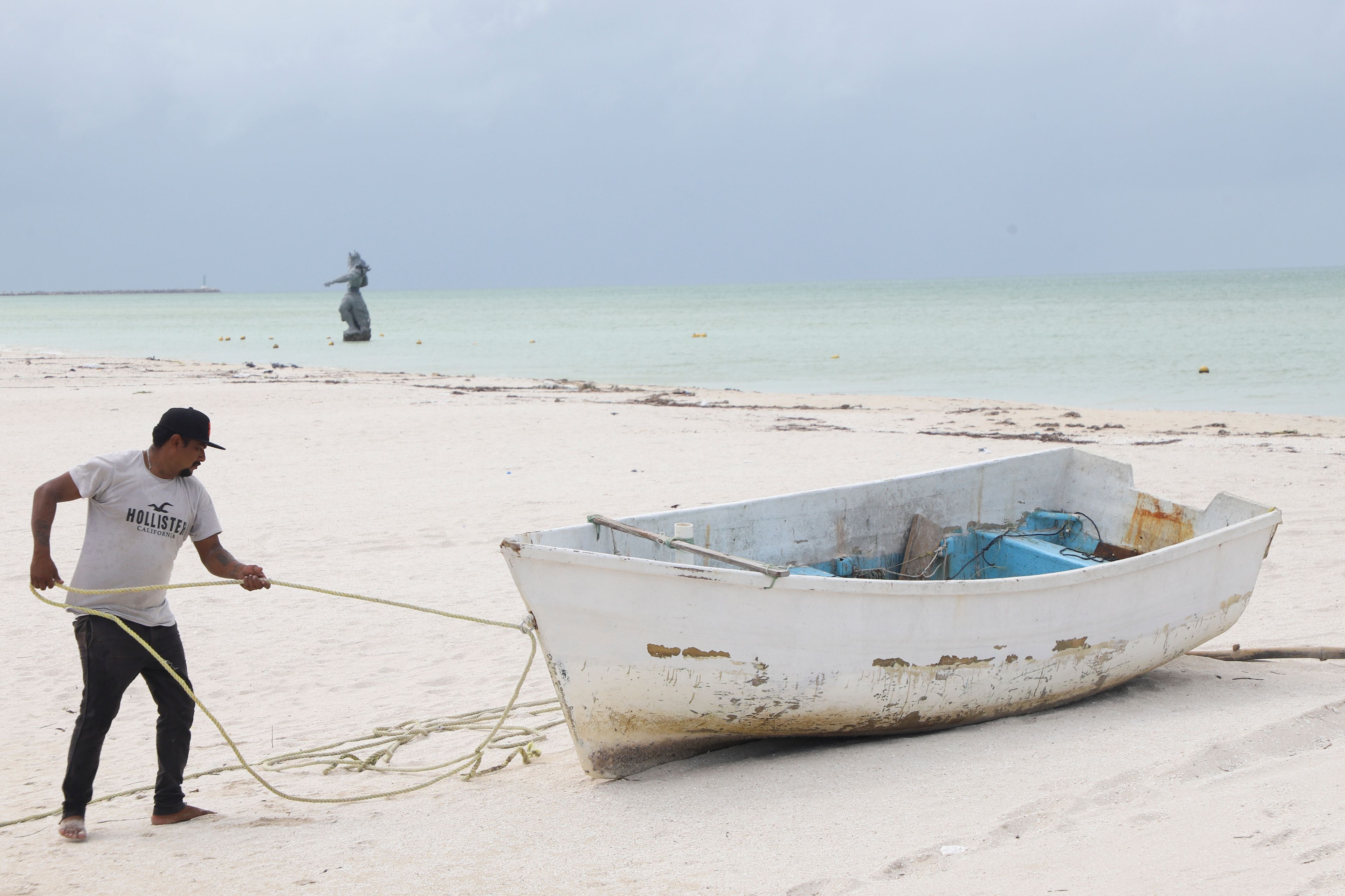 A fisherman prepares his boat for the arrival of Hurricane Milton, in Progreso, Yucatan state, Mexico, Monday, Oct. 7, 2024. (AP Photo/Martin Zetina)