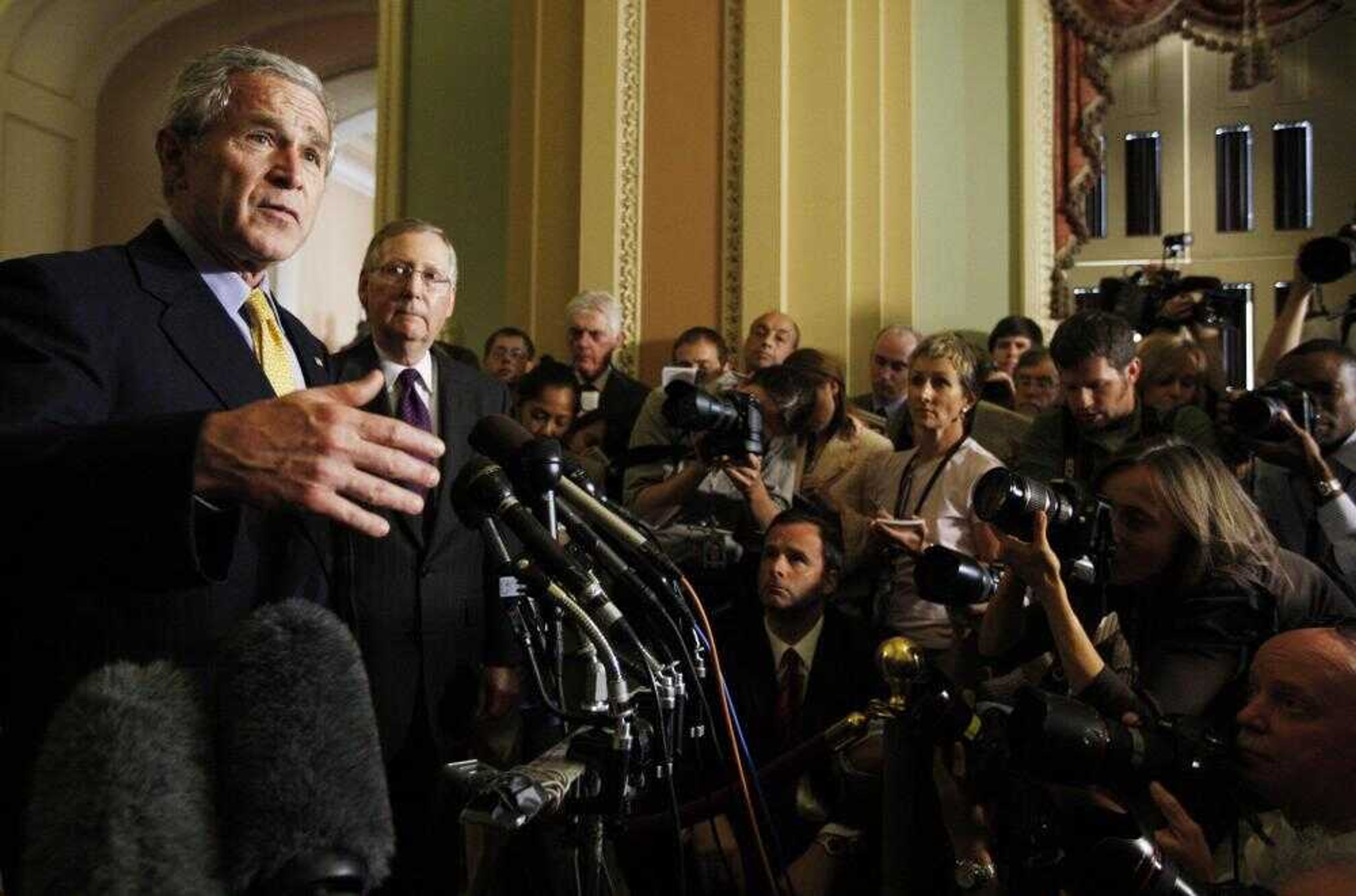 President Bush, left, accompanied by Senate Minority Leader Mitch McConnell of Kentucky, spoke to reporters Tuesday at the Capitol in Washington, D.C., about immigration reform. (Charles Dharapak ~ Associated Press)