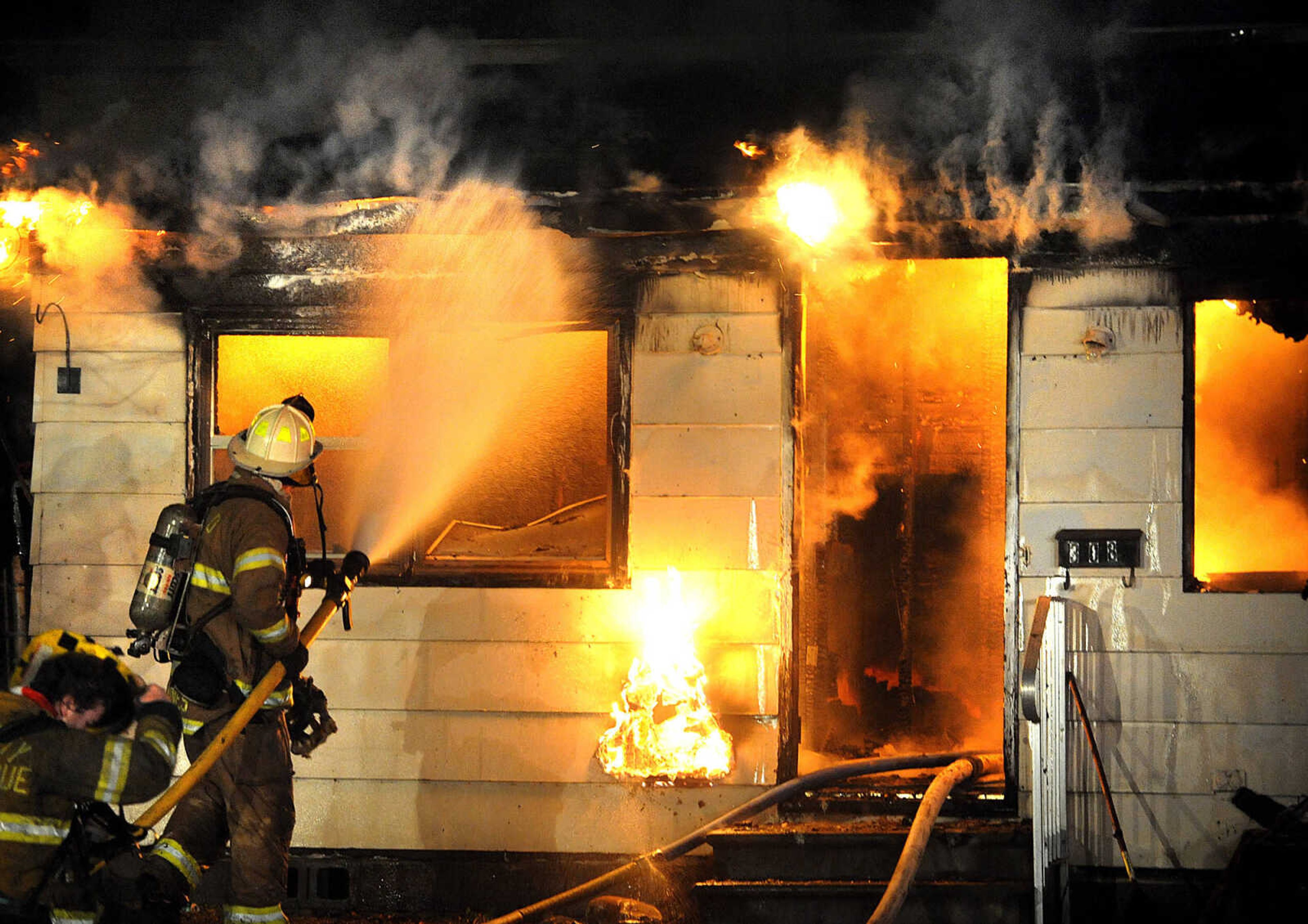 LAURA SIMON ~ lsimon@semissourian.com

Members of the Scott City and Cape Girardeau fire departments battle a blaze at 308 W. Missouri Blvd. in Scott City, Wednesday, Dec. 18, 2013. Nobody was injured in the fire.