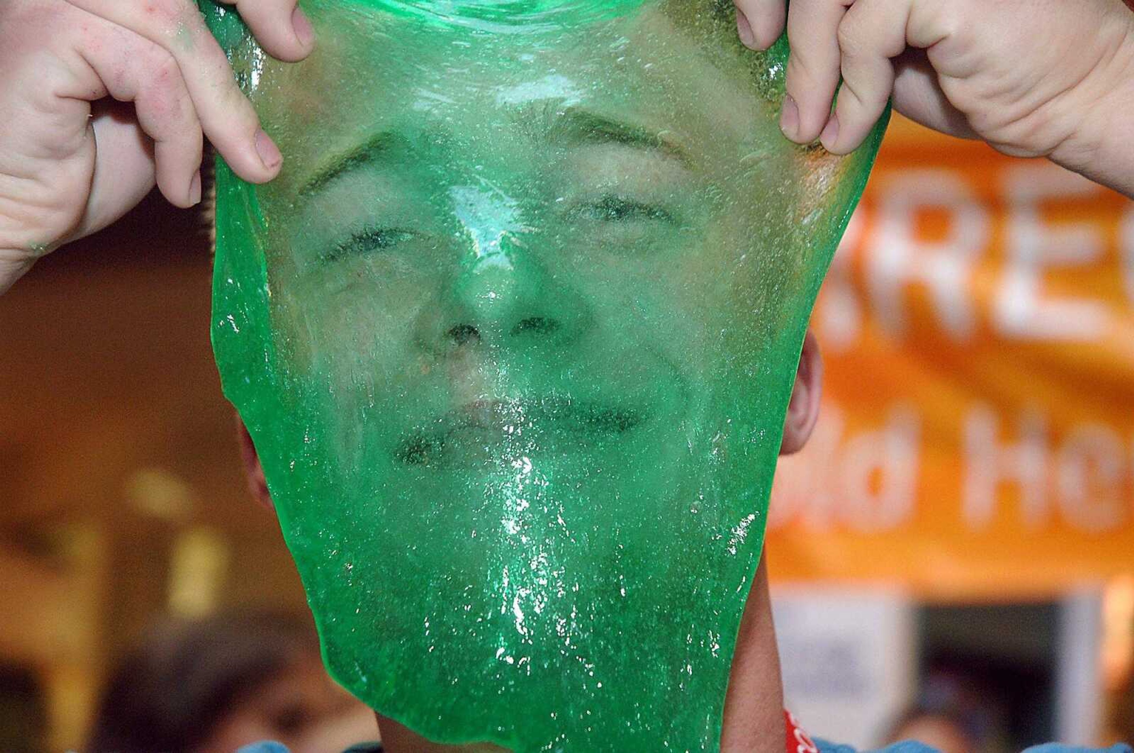 LAURA SIMON~photos@semissourian.com
Science coach Devin Busby plays with the green slime he made Friday as part of Jason Lindsey's attempt to break the world record for largest chemistry class in a single room.  The record was broken with 268 people participating.