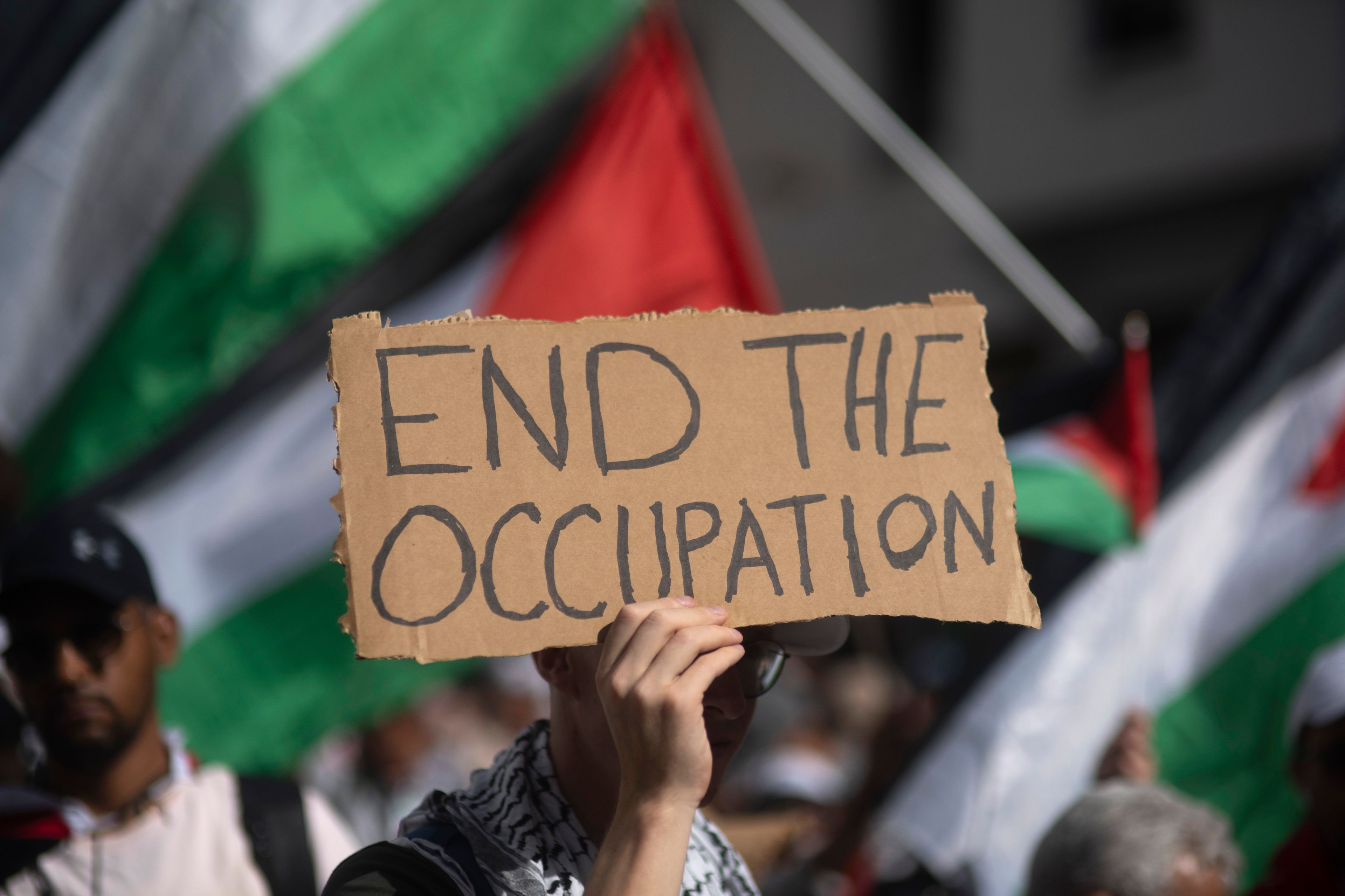 A Moroccan man carries a sign during a protest in support of Gaza and Lebanon, in Rabat, Morocco, Sunday, Oct. 6, 2024 (AP Photo/Mosa'ab Elshamy)