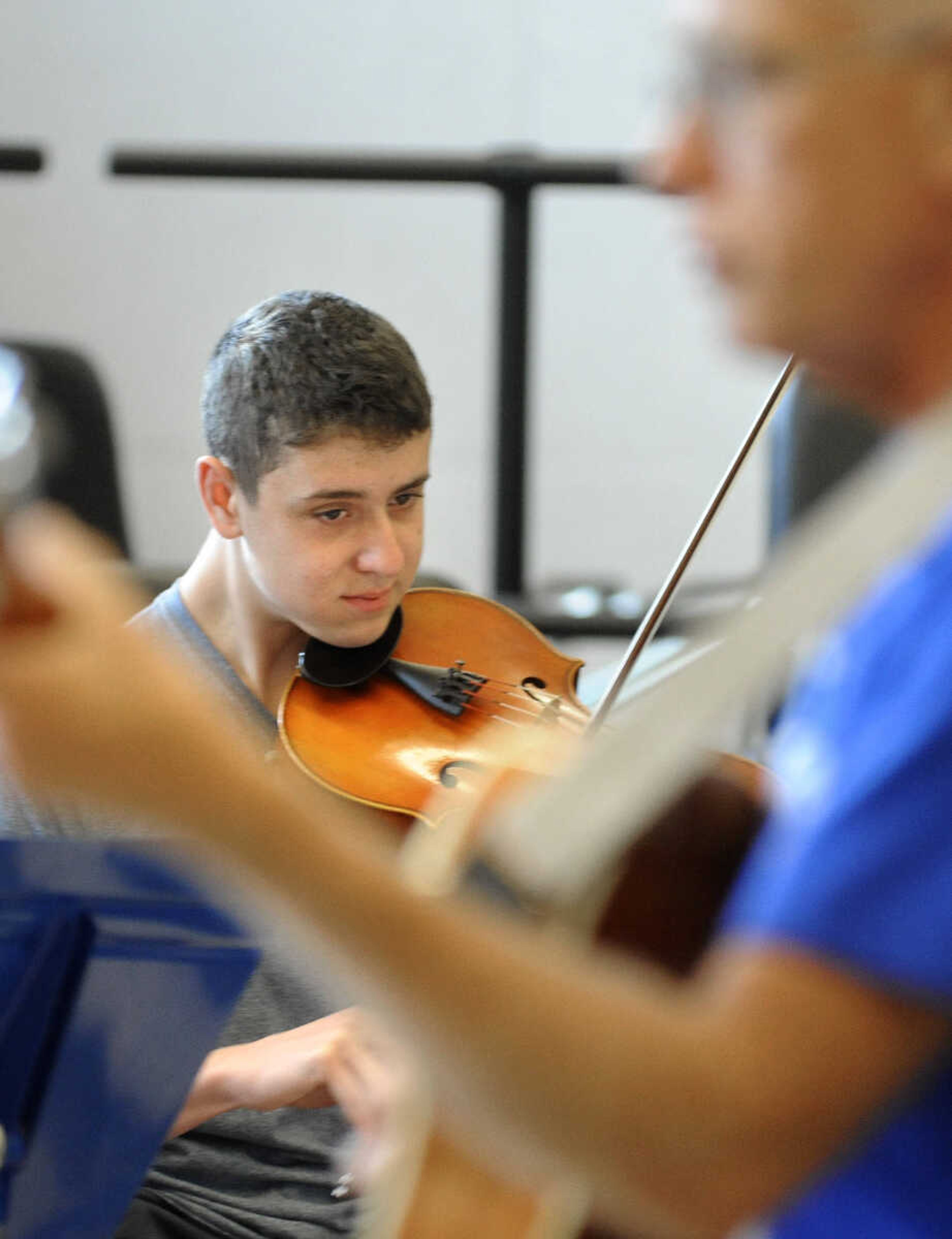 LAURA SIMON ~ lsimon@semissourian.com

Clayton Bridgeman plays his fiddle along with the other seven students in the Southeast Missouri State University Music Academy's Exploring American Fiddle Styles class taught by Steve Schaffner at the River Campus on Wednesday, July 20, 2016. Most of the students have been playing for 2-3 years and are in the Academy's Suzuki Program. The students will perform on Friday at Ratliff Care Center in Cape Girardeau.