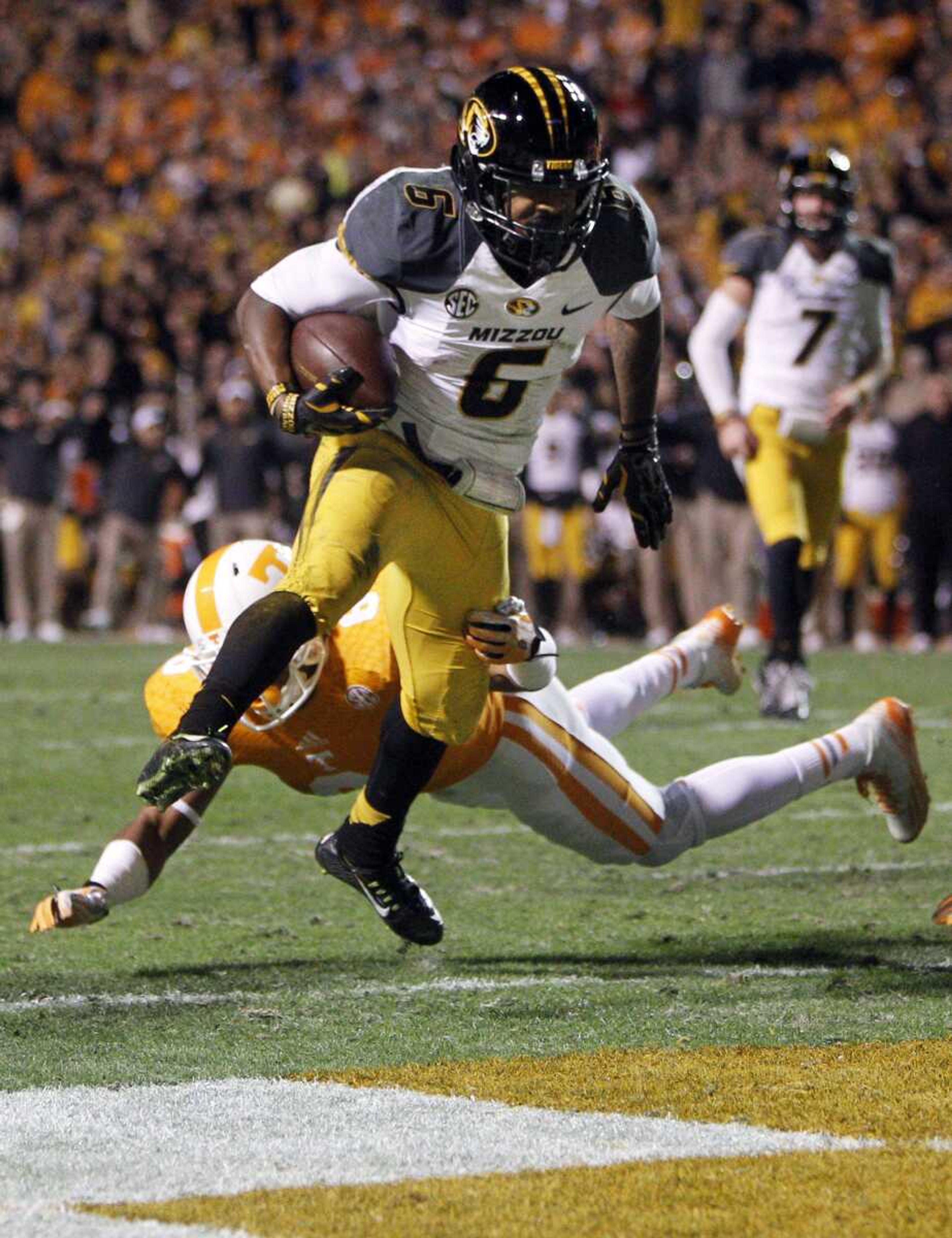 Missouri tailback Marcus Murphy escapes the grasp of Tennessee defensive back Todd Kelly Jr. as he scores a touchdown in the first quarter of Saturday's game in Knoxville, Tenn. (Wade Payne ~ Associated Press)