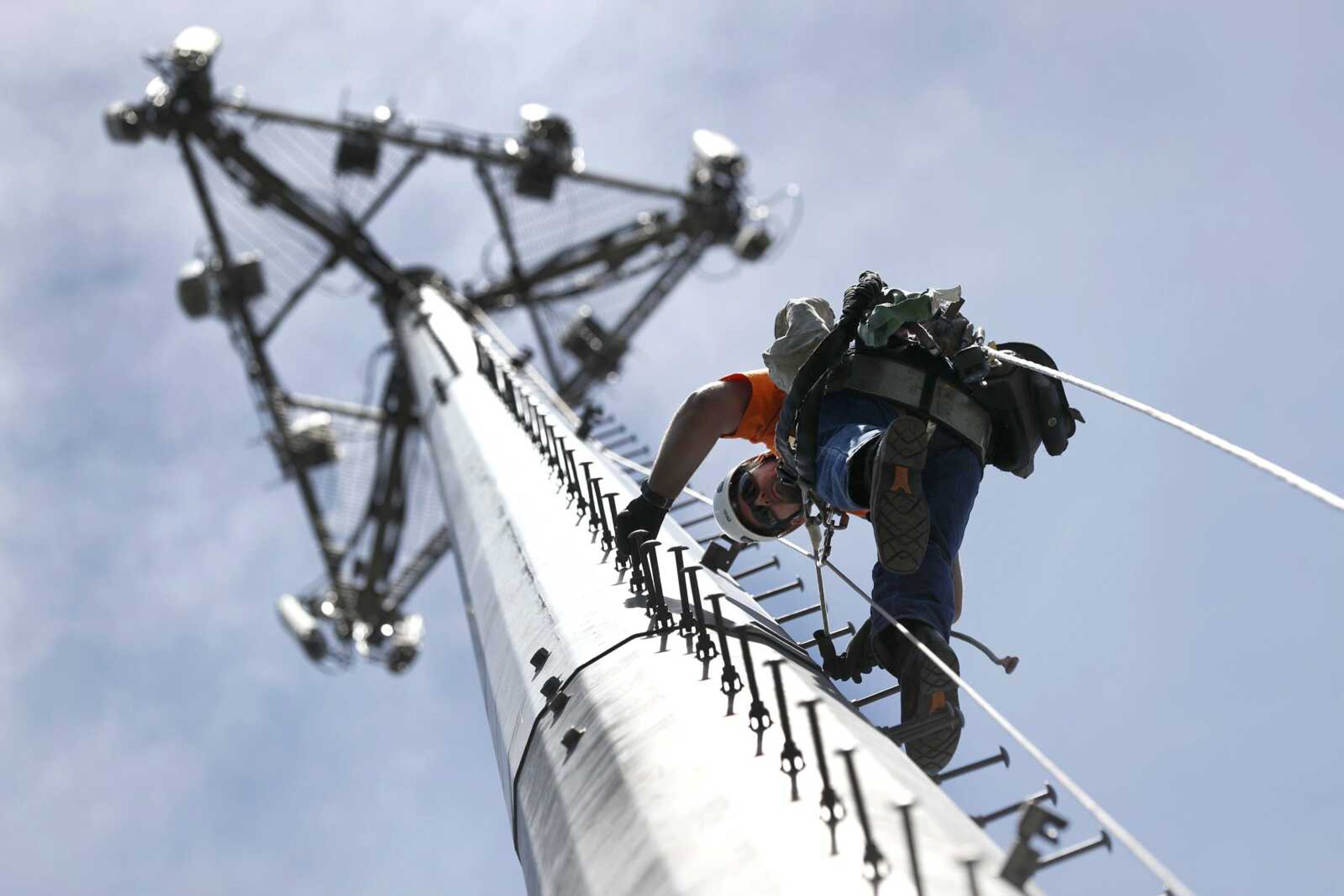 Nick Blase climbs a cellular tower to perform maintenance May 22 in High Ridge, Missouri. Blase is an Army Reserve veteran who works for True North Management Services, a company that builds and manages cellphone networks and has a program to train and hire veterans such as Blase.