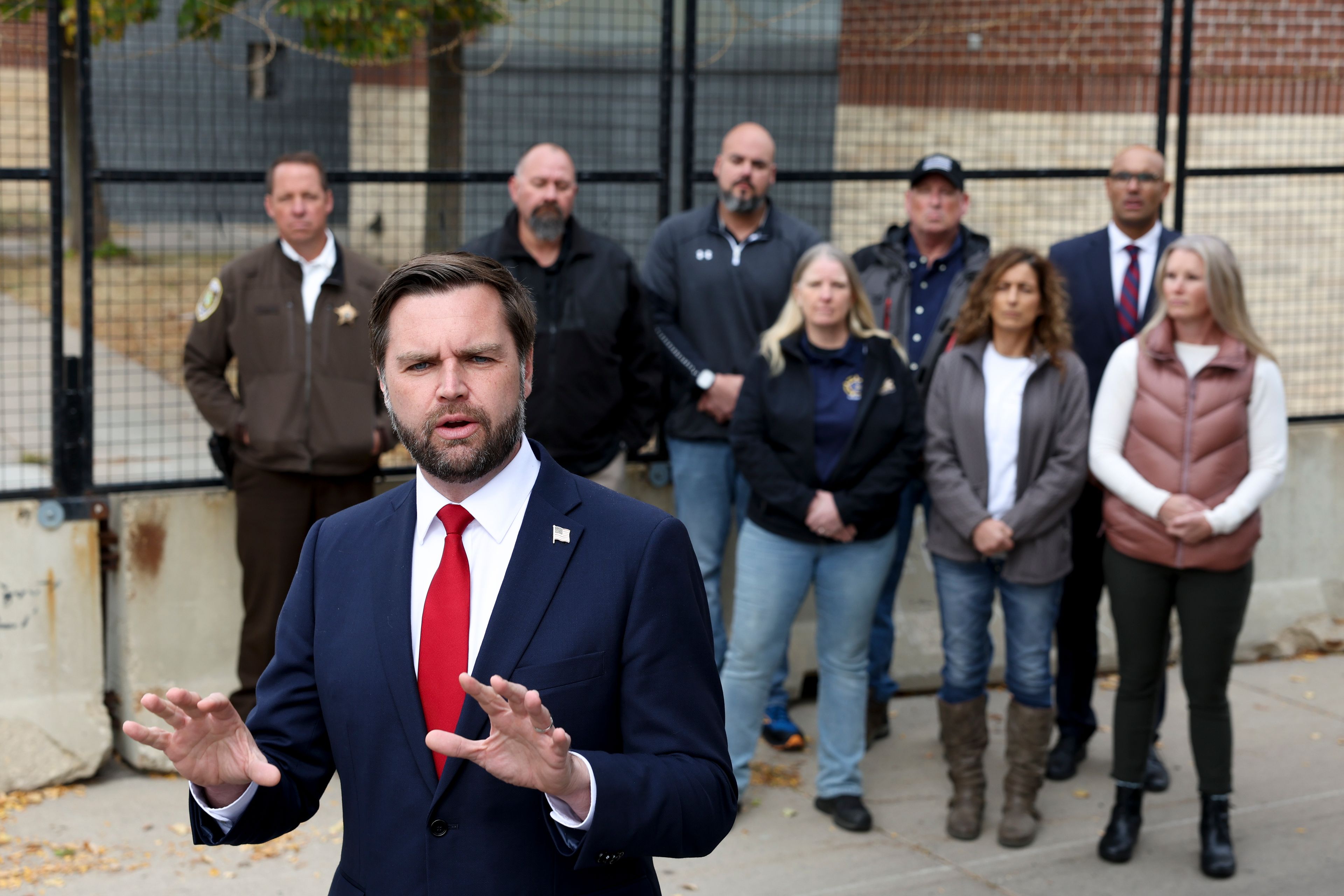 Republican vice presidential nominee Sen. JD Vance, R-Ohio, speaks as law enforcement officers look on in front of the Minneapolis police department's 3rd precinct, which was ransacked and burned after the murder of George Floyd in 2020, Monday, Oct. 14, 2024, in Minneapolis. (AP Photo/Ellen Schmidt)