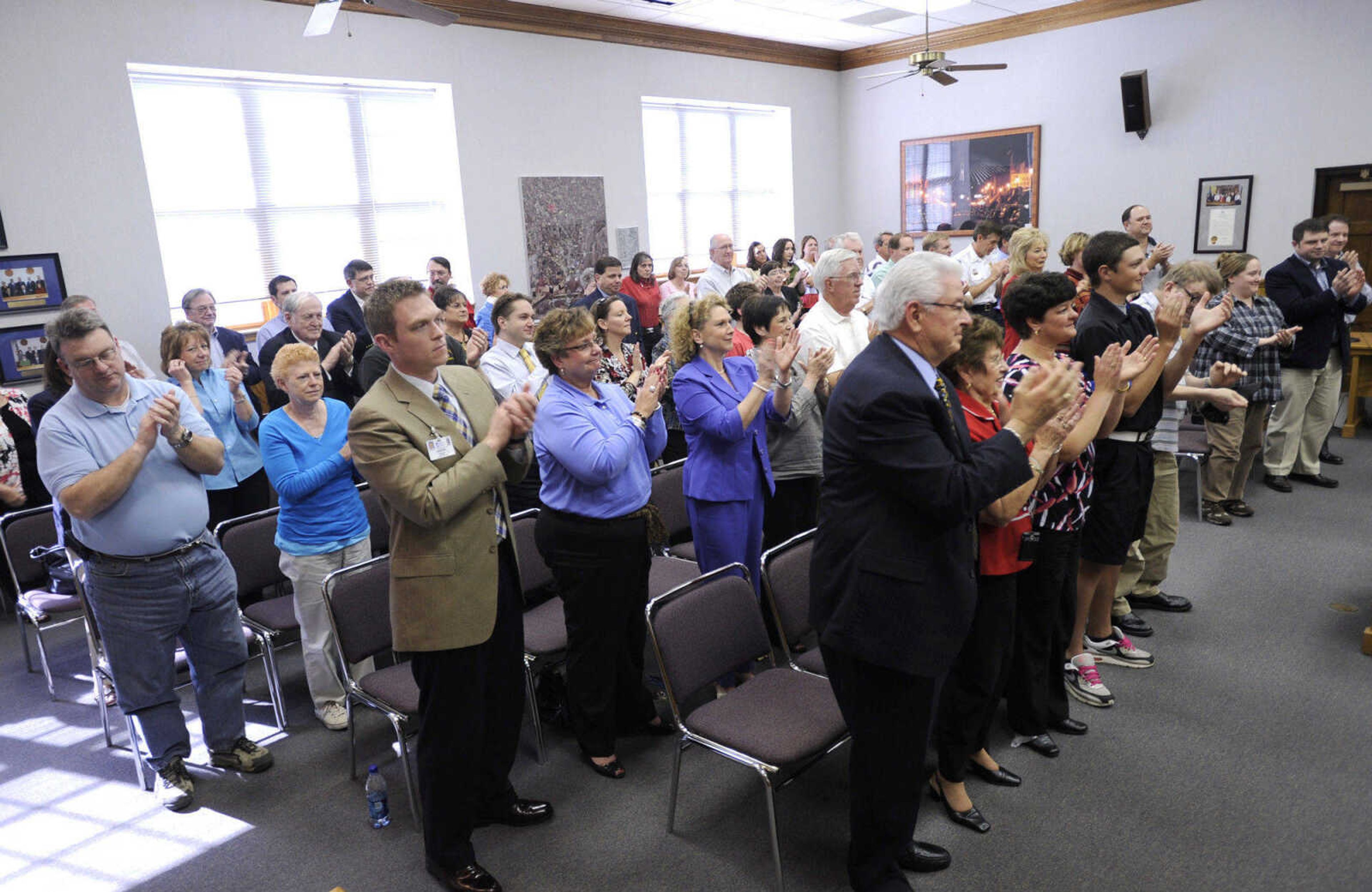 The audience applauds Jay Knudtson for his service to Cape Girardeau as mayor since 2002.