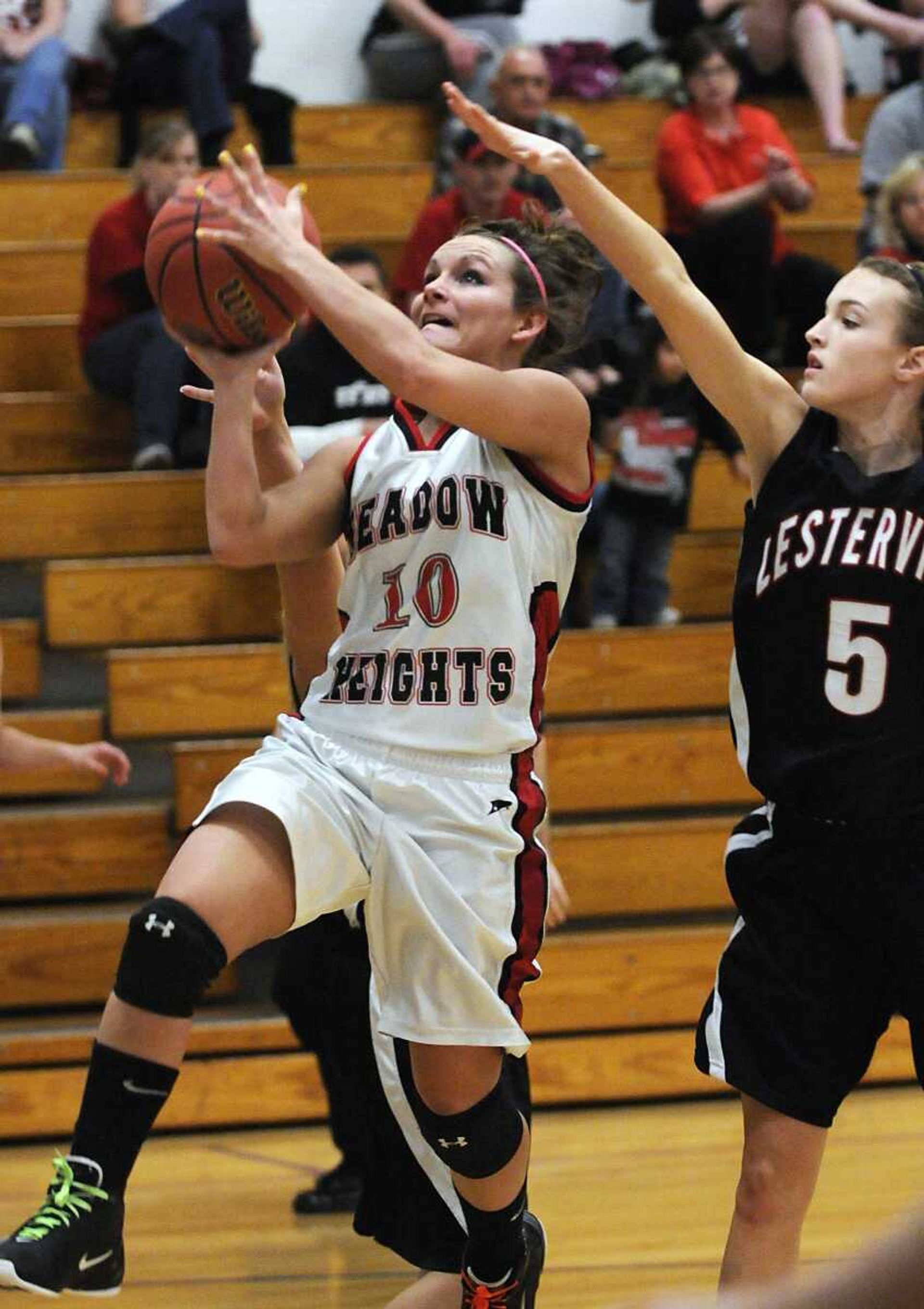 Meadow Heights' Gina Cureton takes a shot against Lesterville's Taylor Cook during the first quarter of the Class 2 District 3 title game Thursday in Oran. Meadow Heights won 84-50.