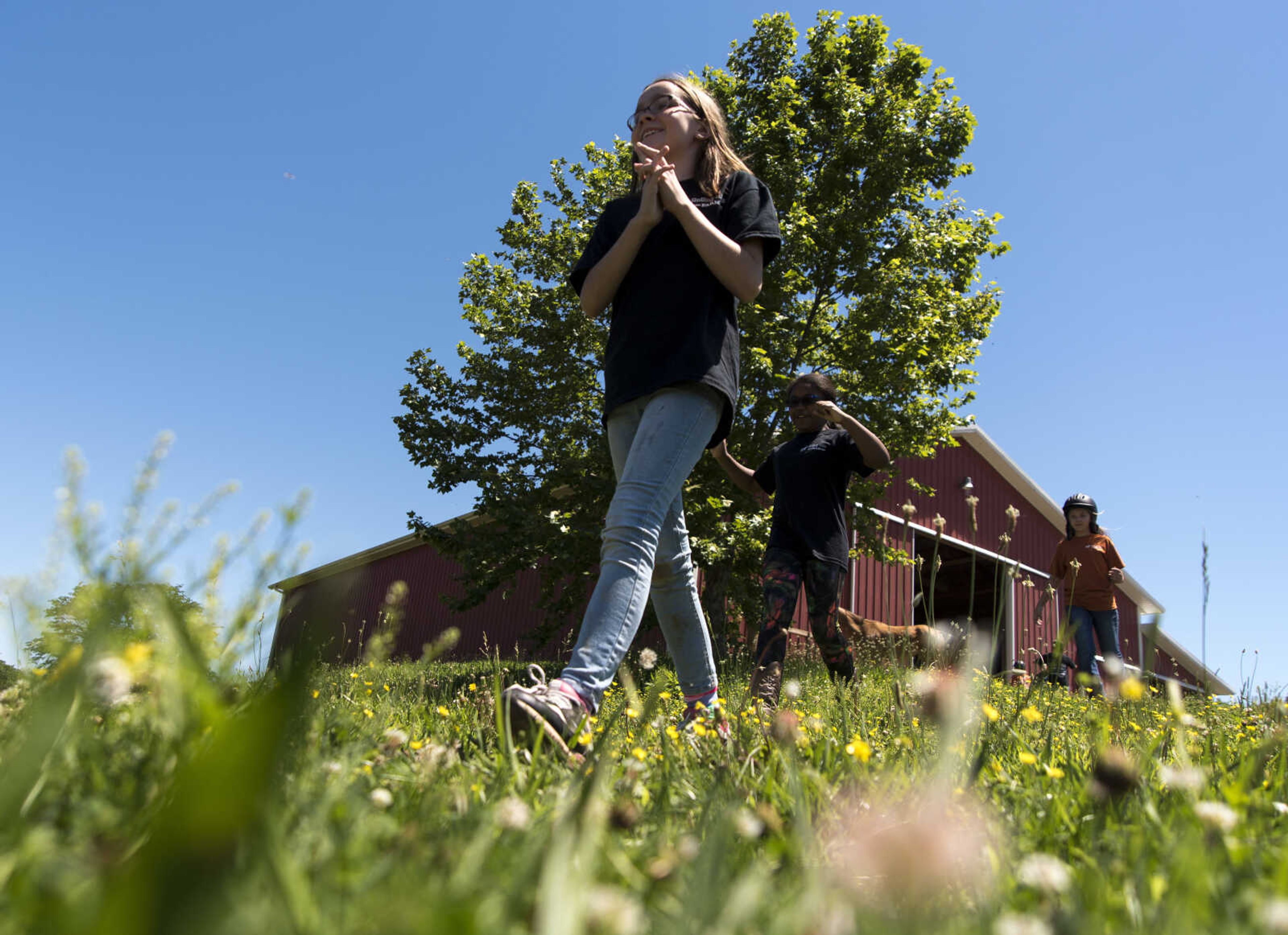 Serenity Glasser, 10, walks up to the miniature horses during the Rolling Hills Youth Day Camp Wednesday, June 7, 2017 in Cape Girardeau.