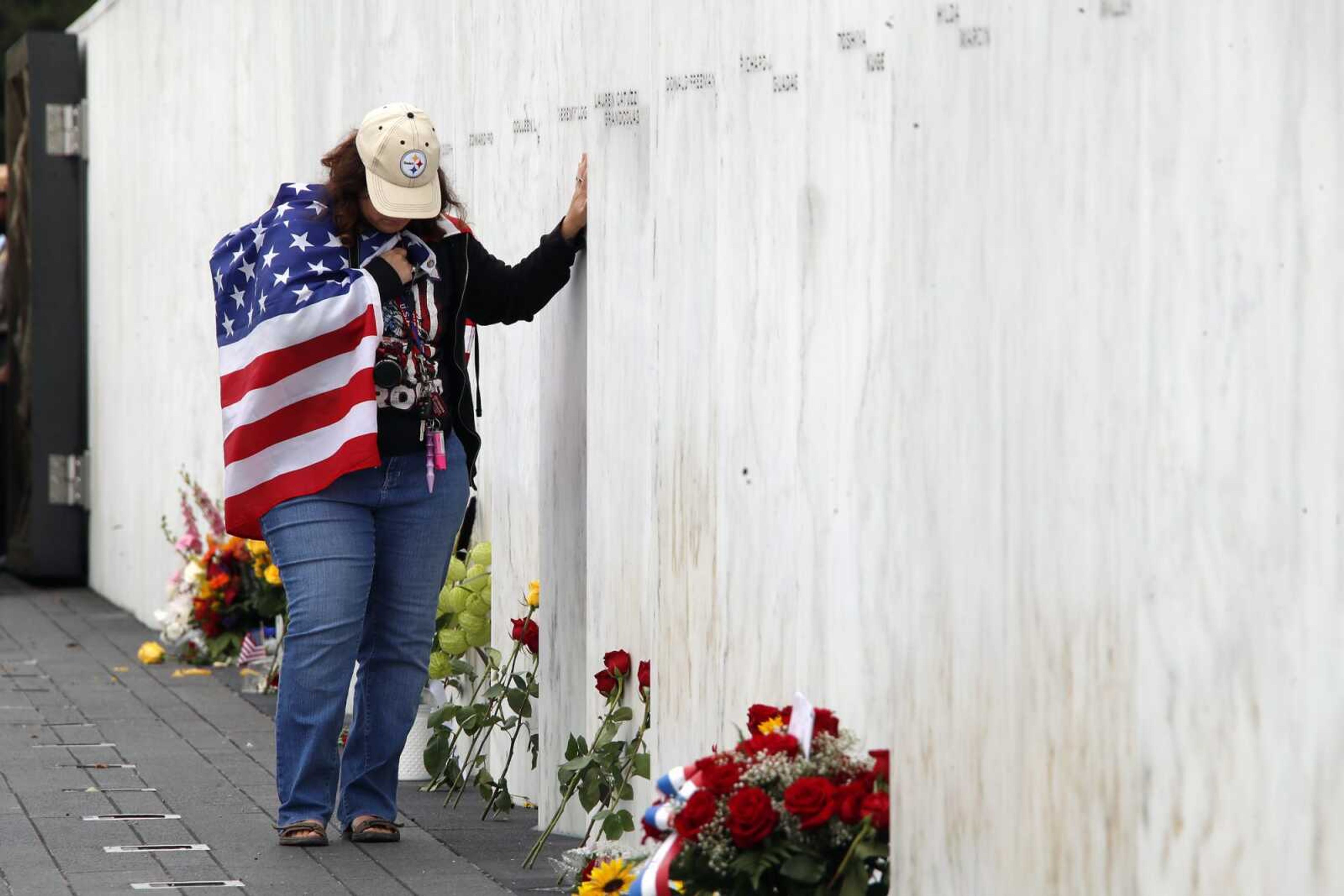 Chrissy Bortz of Latrobe, Pa., pays her respects at the Wall of Names at the Flight 93 National Memorial in Shanksville, Pa. after a Service of Remembrance Tuesday, Sept. 11, 2018, as the nation marks the 17th anniversary of the Sept. 11, 2001 attacks. The Wall of Names honor the 40 people killed in the crash of Flight 93. (AP Photo/Gene J. Puskar)