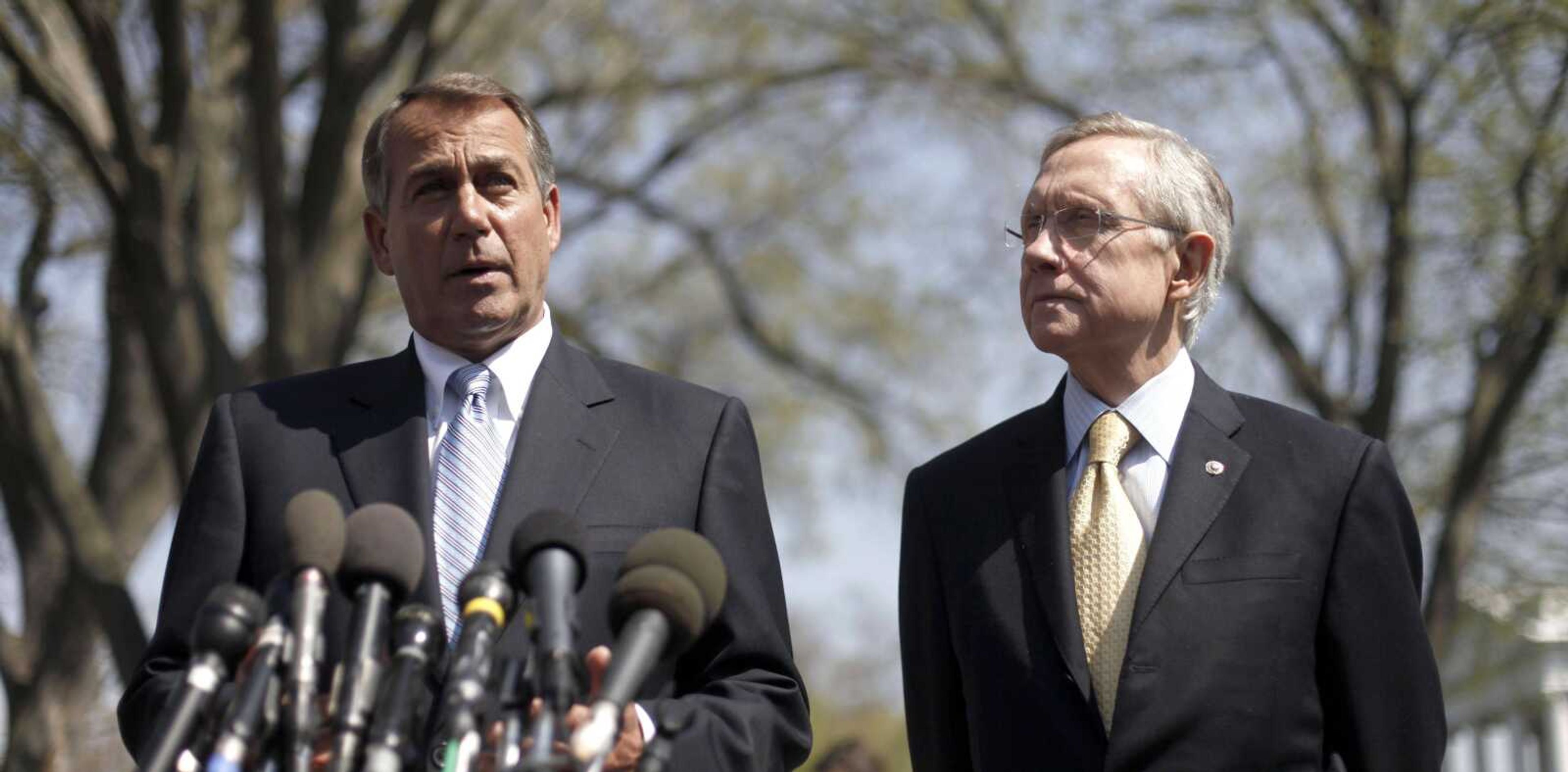 House Speaker John Boehner of Ohio, left, accompanied by Senate Majority Leader Harry Reid of Nevada, speaks to reporters outside the White House after their meeting Thursday with President Obama regarding the budget and possible government shutdown. (Pablo Martinez Monsivais ~ Associated Press)