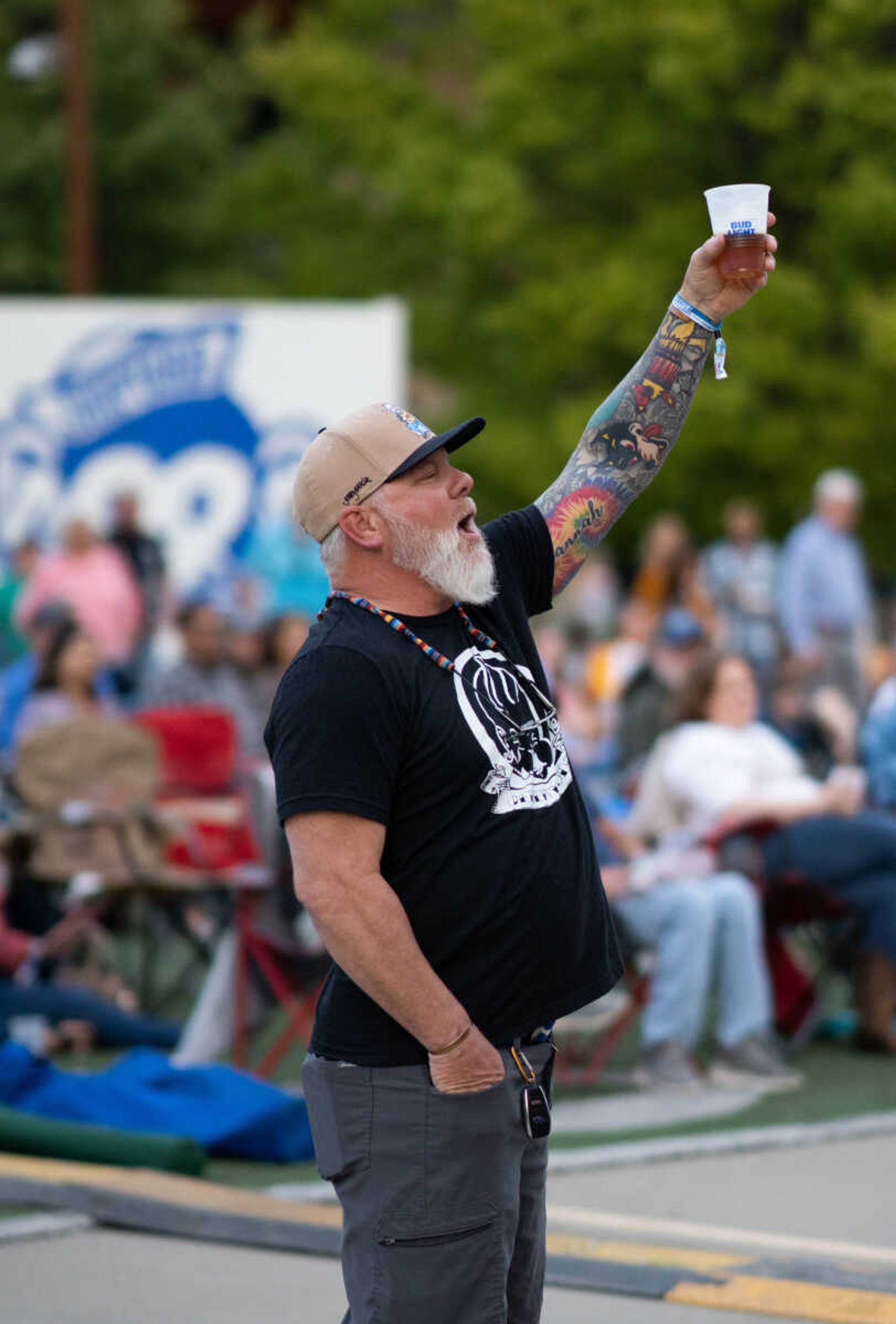 An attendee raises his beer toward the stage during the first day of Shipyard Music Festival 2022. Local food vendors create menus especially for Shipyard.